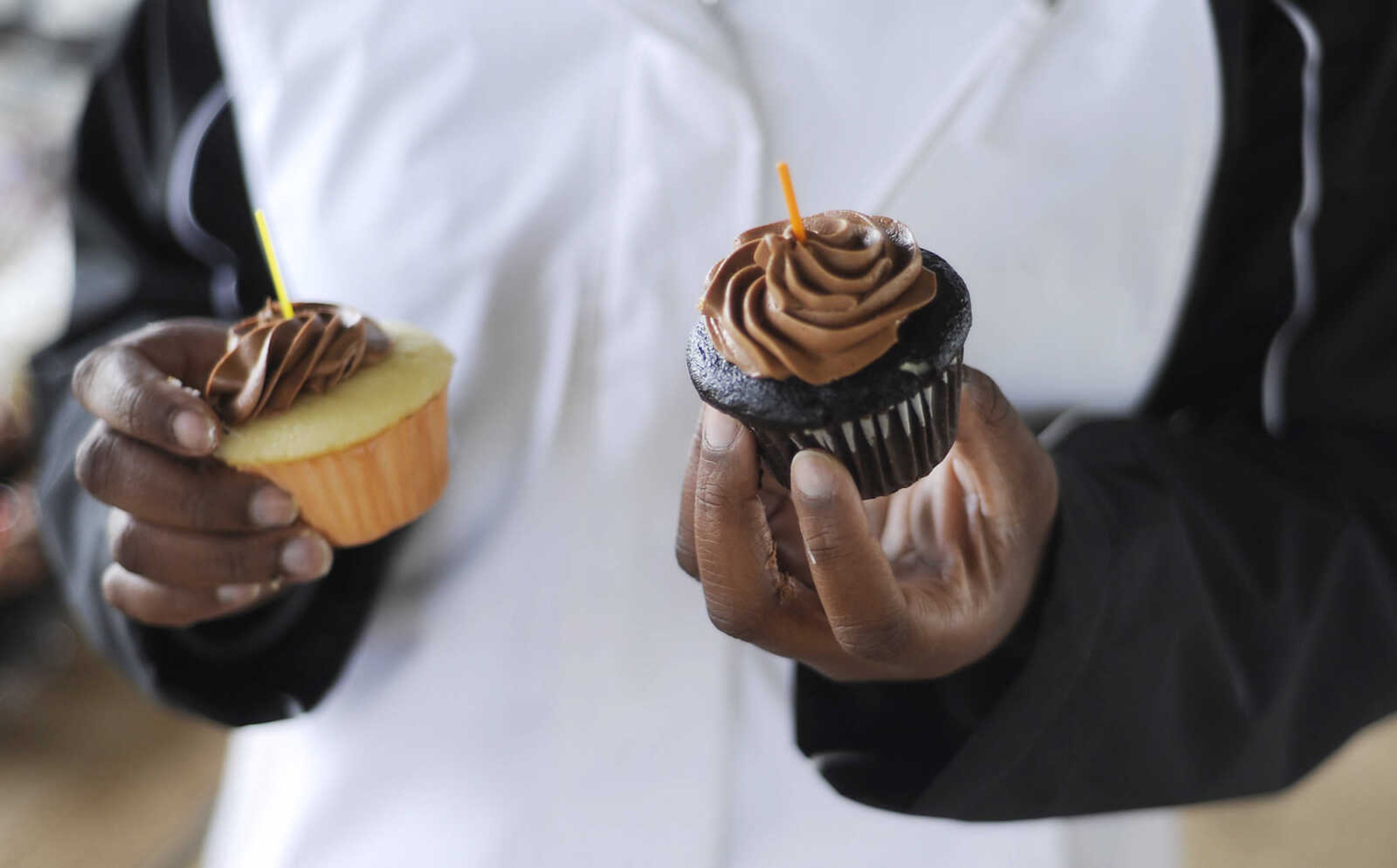 A race worker holds out cupcakes for the runners during the 2013 Cupcake Challenge Sunday, May 5, at Arena Park in Cape Girardeau. Runners could have time deducted from their finish time for every cupcake they ate during the the 5k race, there was also a 1-mile kids race, which is a fundraiser for Hope Children's Home.