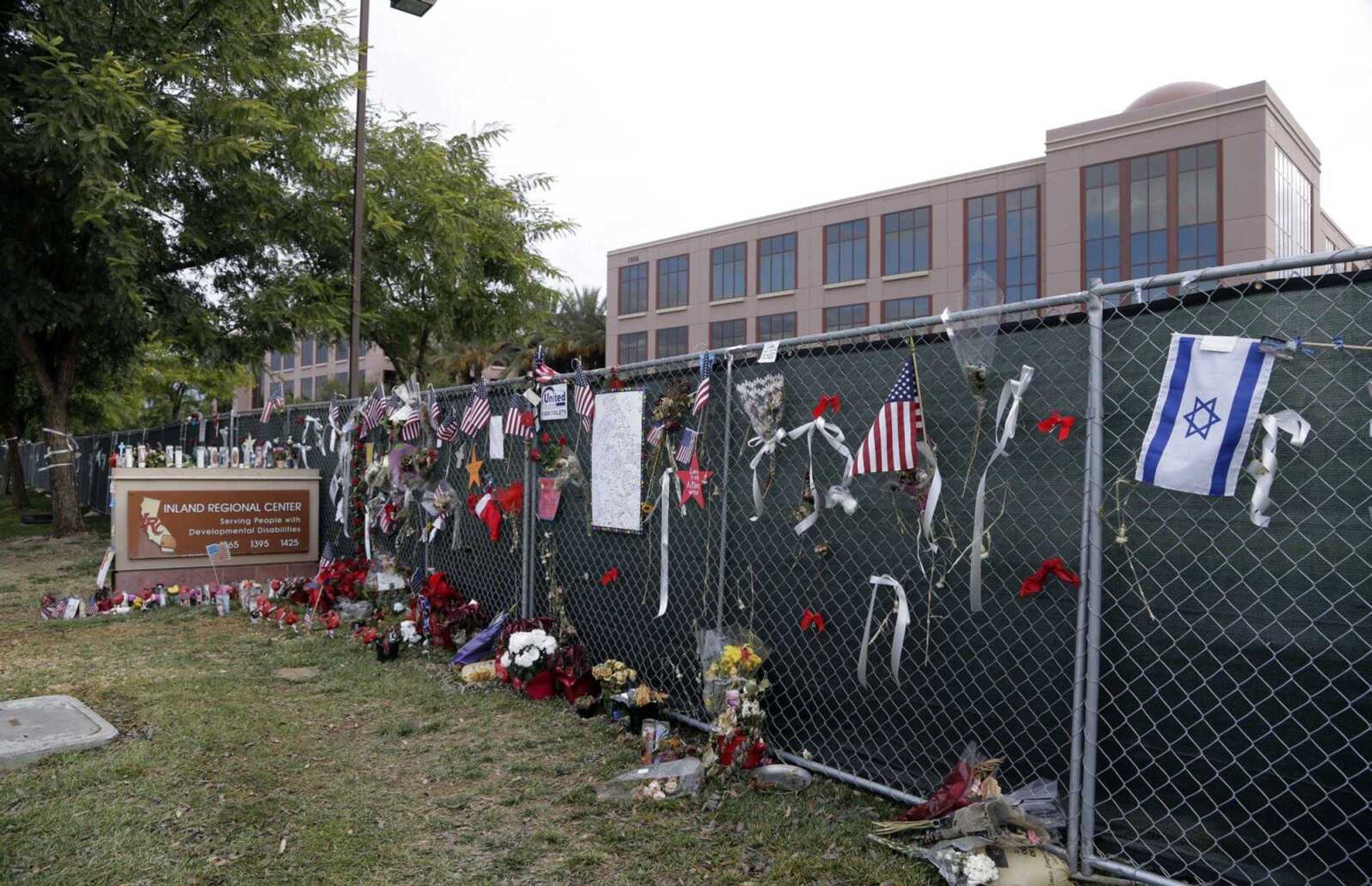 A chain-link fence is in place as workers return to work at the Inland Regional Center for the first time since the Dec. 2 massacre. (Nick Ut ~ Associated Press)