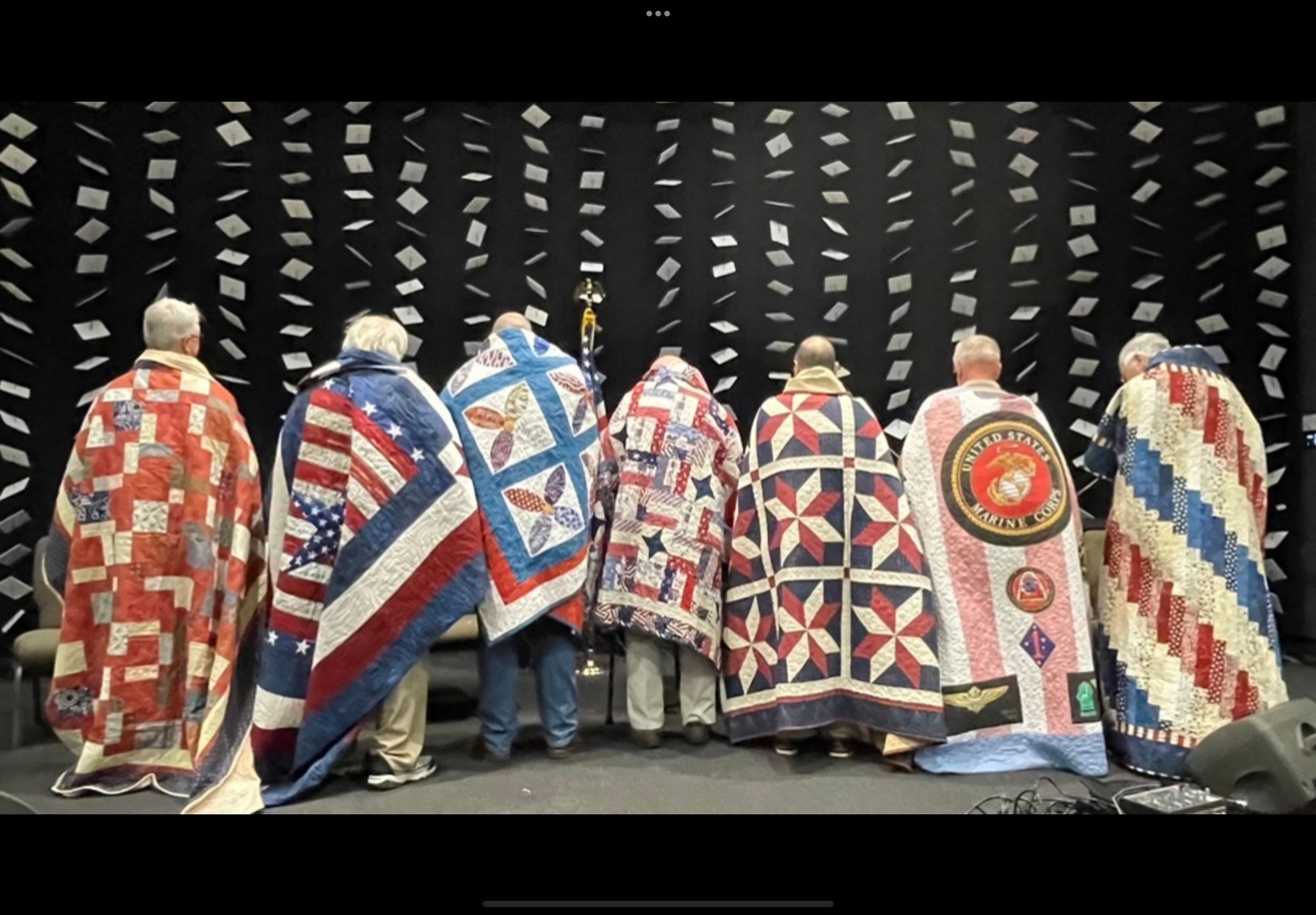 The River Heritage quilt guild hosted its 11th Valor Quilts presentation ceremony on Nov. 11, 2024. Seven veterans were honored with quilts made by guild members. Pictured from the left to right are: James Mitchell, U.S. Navy, (quilt made and presented by Kelly Irvin), Morris Owens, U.S. Army (quilt made and presented by Laura Delgado), Kyle Wheeler, U.S. Army National Guard, (quilt made and presented by Debbie Morris), John Hilpert, U.S. Army, (quilt made and presented by Kate Nichols), Kevin McMeel, and U.S. Coast Guard, (quilt made and presented by Beverly McMeel), Matt Kiefner, U.S. Marine Corps, (quilt made and presented by Karla Kiefner) and Dr. Stan Sides, U.S. Navy/U.S. Naval Reserve, (quilt made by Donna Irwin and Karla Kiefner, presented by Donna Irwin).  This quilt presentation is one way we can convey our sincere gratitude to our veterans for their service, sacrifice and valor to our country and to each of us, said Donna Irwin, guild member. Special entertainment was provided by Paige Kiefner Cook by singing the  National Anthem.