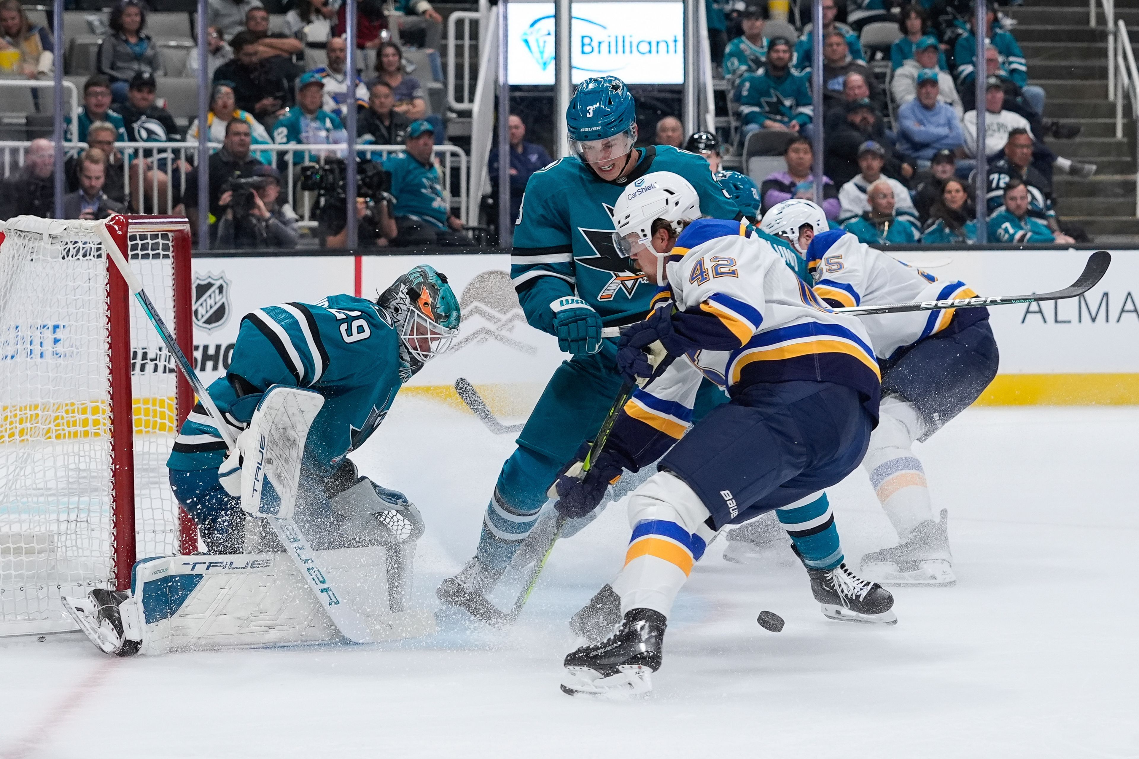 San Jose Sharks goaltender Mackenzie Blackwood, left, stops a shot during the second period of an NHL hockey game against the St. Louis Blues, Thursday, Oct. 10, 2024, in San Jose, Calif. (AP Photo/Godofredo A. Vásquez)