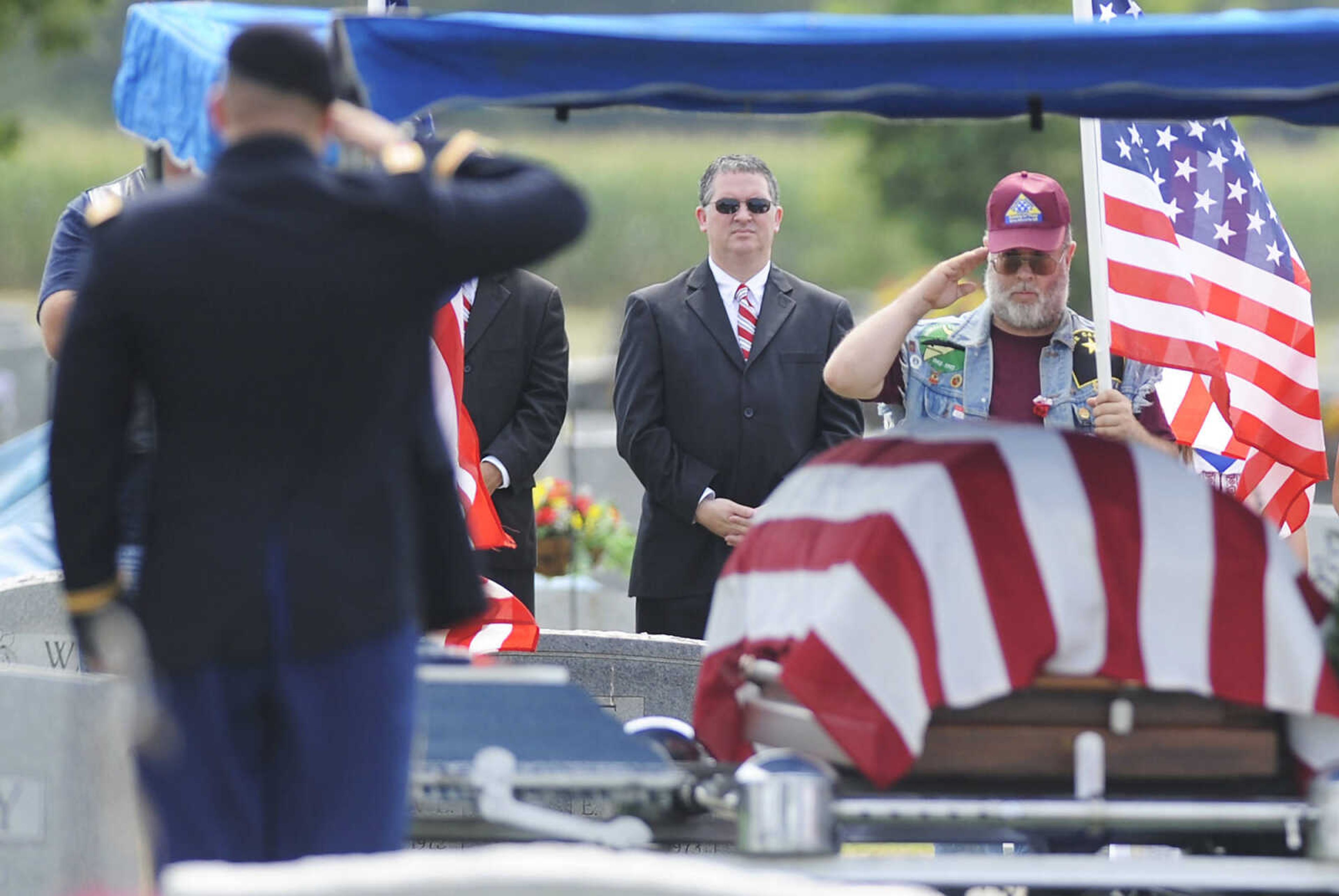 Members of the honor guard and the Patriot Guard Riders salute  during the funeral for U.S. Army Air Forces 1st Lt. Warren G. Moxley Tuesday, July 3, at the Odd Fellows Cemetery in Charleston, Mo. A pilot with the 67th Tactical Recon Group's 107th Observation Squadron Moxley was killed on March 15, 1945, when his F6, a photo-reconnaissance model of the P-51 Mustang, was shot down over Germany by anti-aircraft fire. His remains were identified using DNA earlier this year.