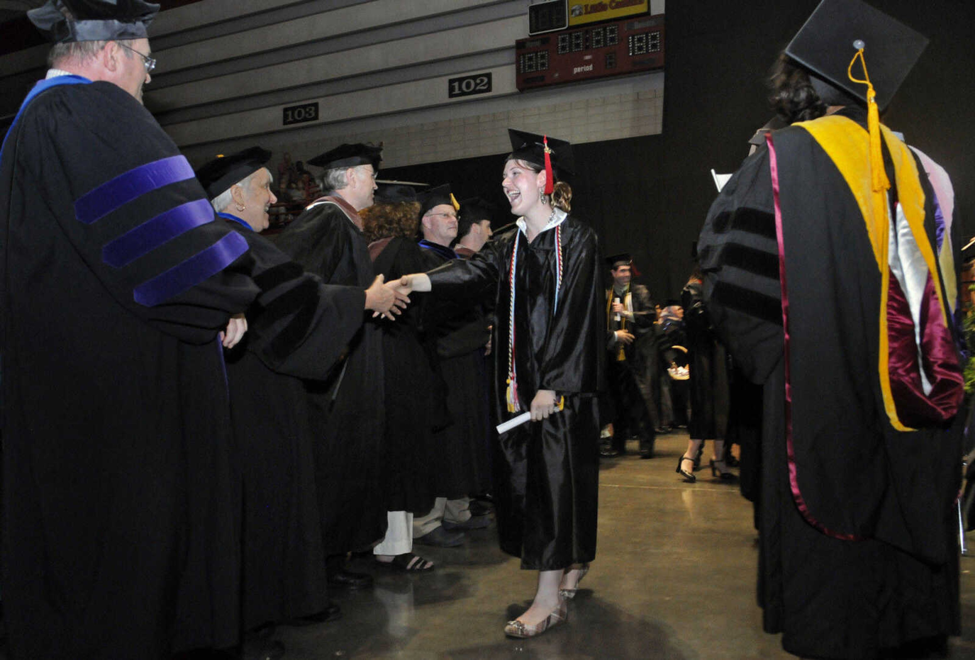 KRISTIN EBERTS ~ keberts@semissourian.com

Kelly Owns shakes hands with professors and staff from the College of Liberal Arts after receiving her diploma during Southeast Missouri State University's 2010 Commencement at the Show Me Center on Saturday, May 15.