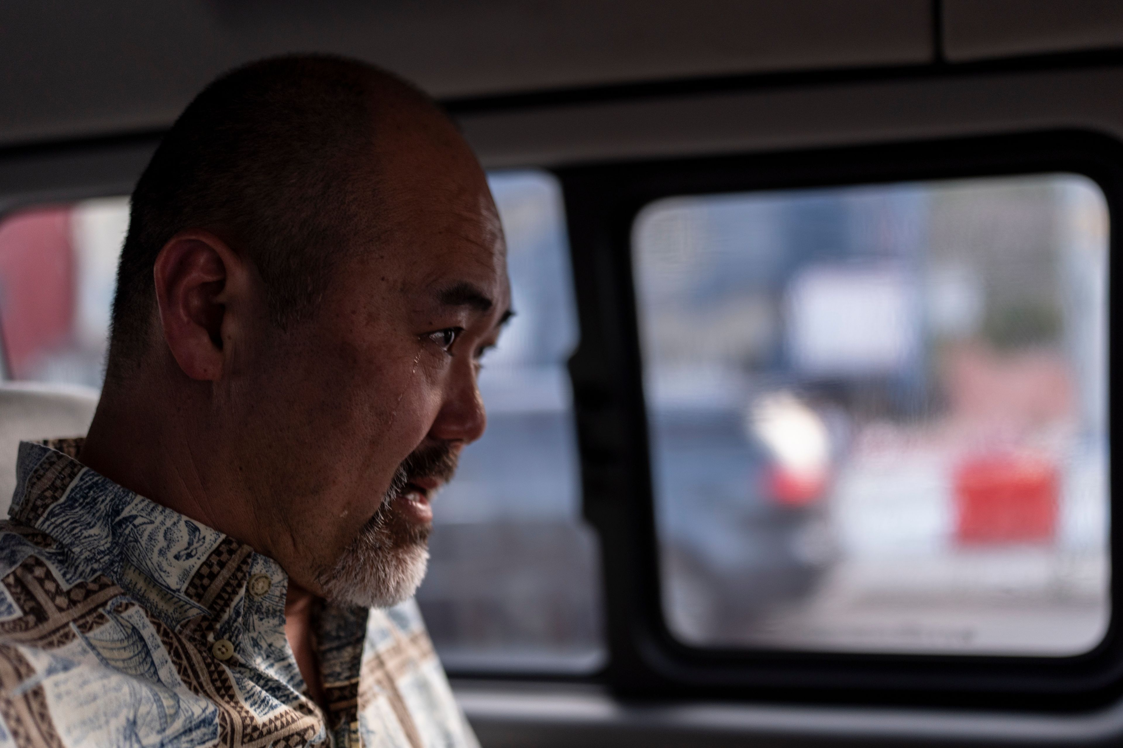 A teardrop rolls down the cheek of Kenneth Barthel, who was adopted from South Korea at the age of six, as he sits in a minivan in Busan, South Korea, Friday, May 17, 2024, after spending the day trying to uncover the details of his early life and find his birth family. (AP Photo/Jae C. Hong)