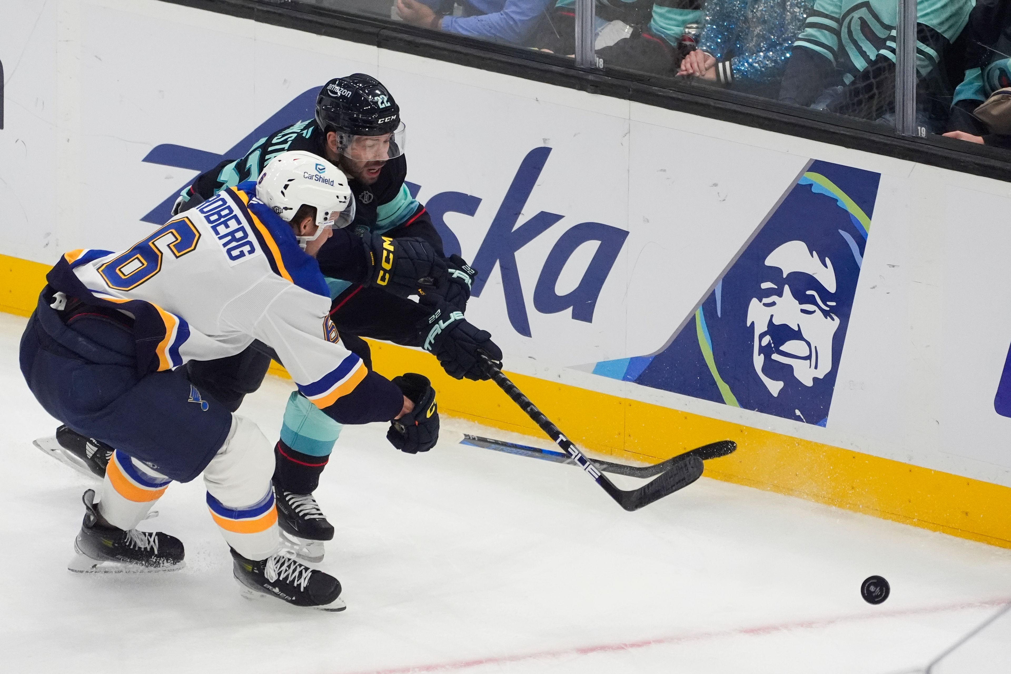 St. Louis Blues defenseman Philip Broberg (6) and Seattle Kraken right wing Oliver Bjorkstrand (22) vie for the puck during the first period of an NHL hockey game Tuesday, Oct. 8, 2024, in Seattle. (AP Photo/Lindsey Wasson)