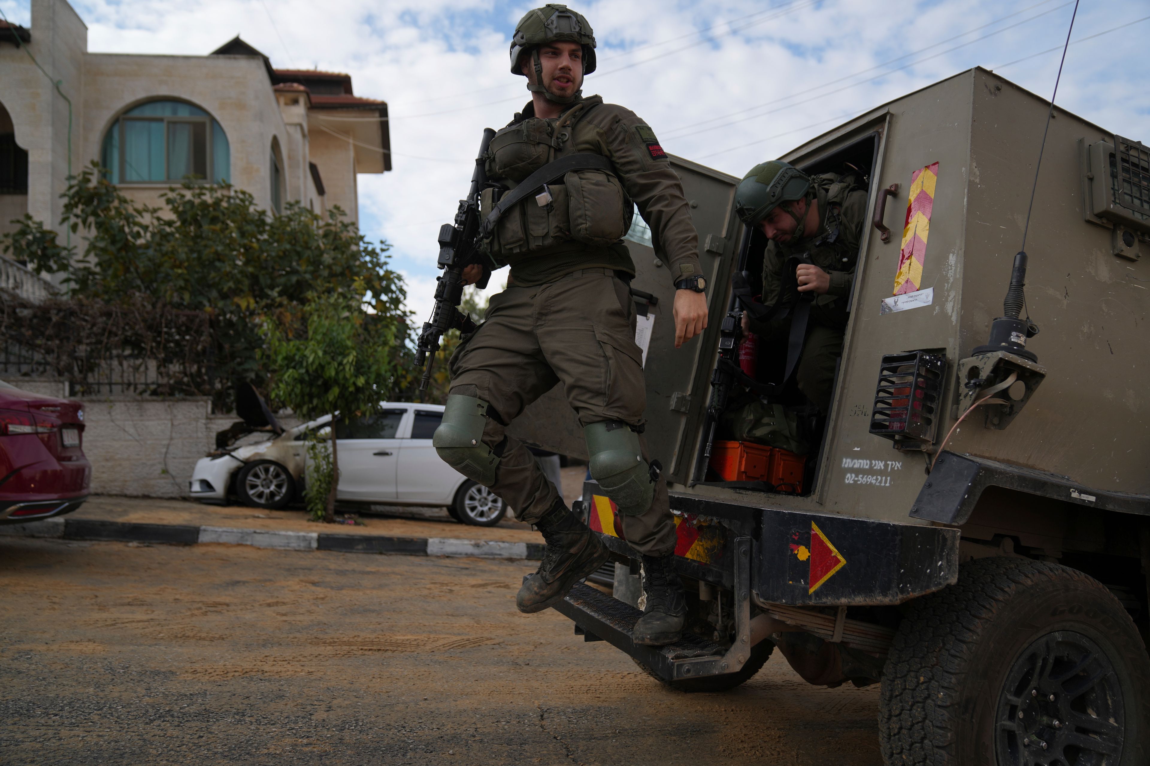 Israeli army investigators arrive at the site of the early morning attack of Israeli settlers, that left at least 18 burnt vehicles, on the outskirts of the West Bank city of al-Bireh Monday, Nov. 4, 2024. (AP Photo/Nasser Nasser)