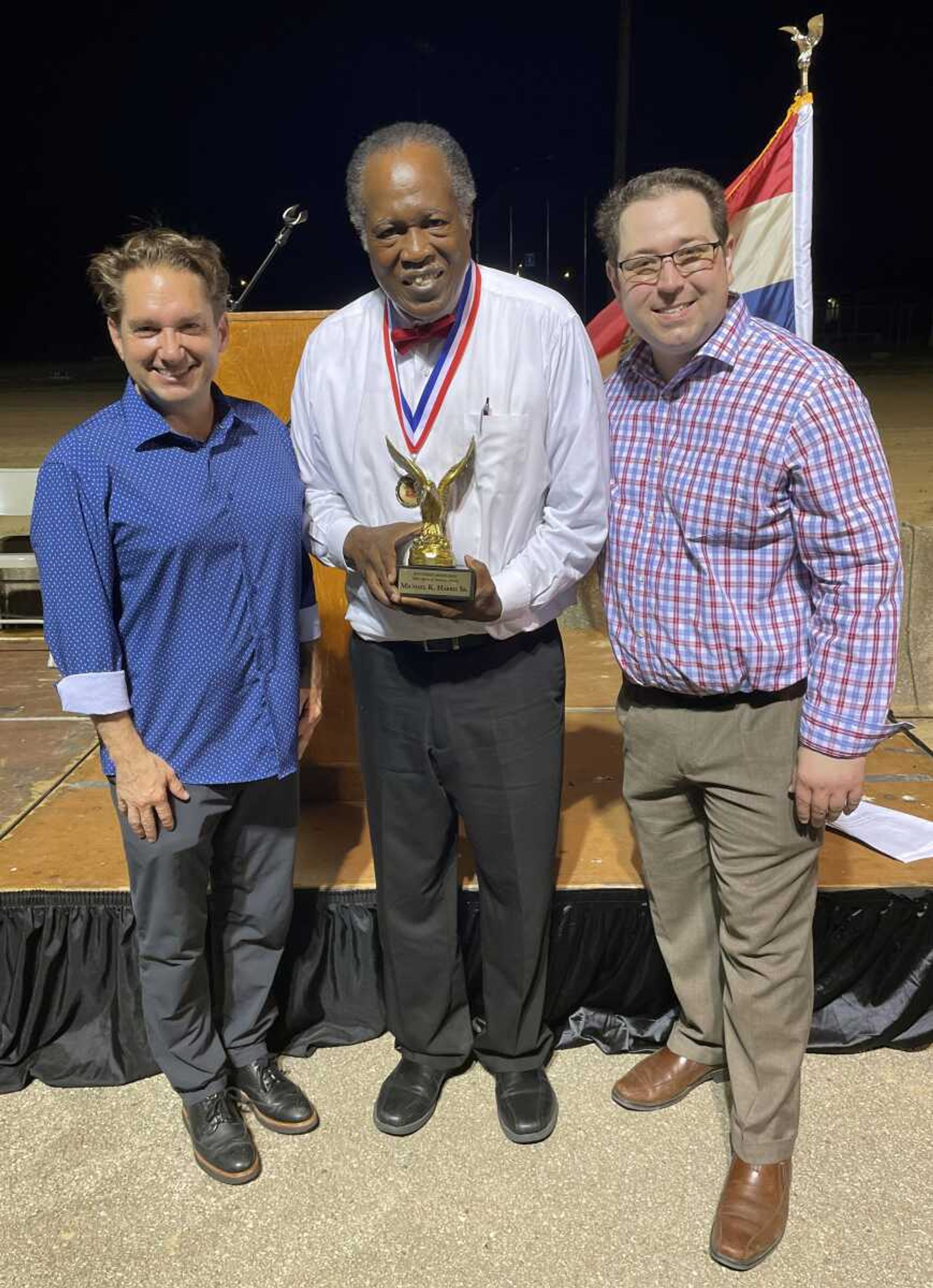 Michael K. Harris Sr. of Sikeston, Missouri, center, accepts the 2023 Southeast Missourian Spirit of America Award from Jon K. Rust, Southeast Missourian publisher and Rust Communications president, left, and Lucas Presson, Southeast Missourian assistant publisher.