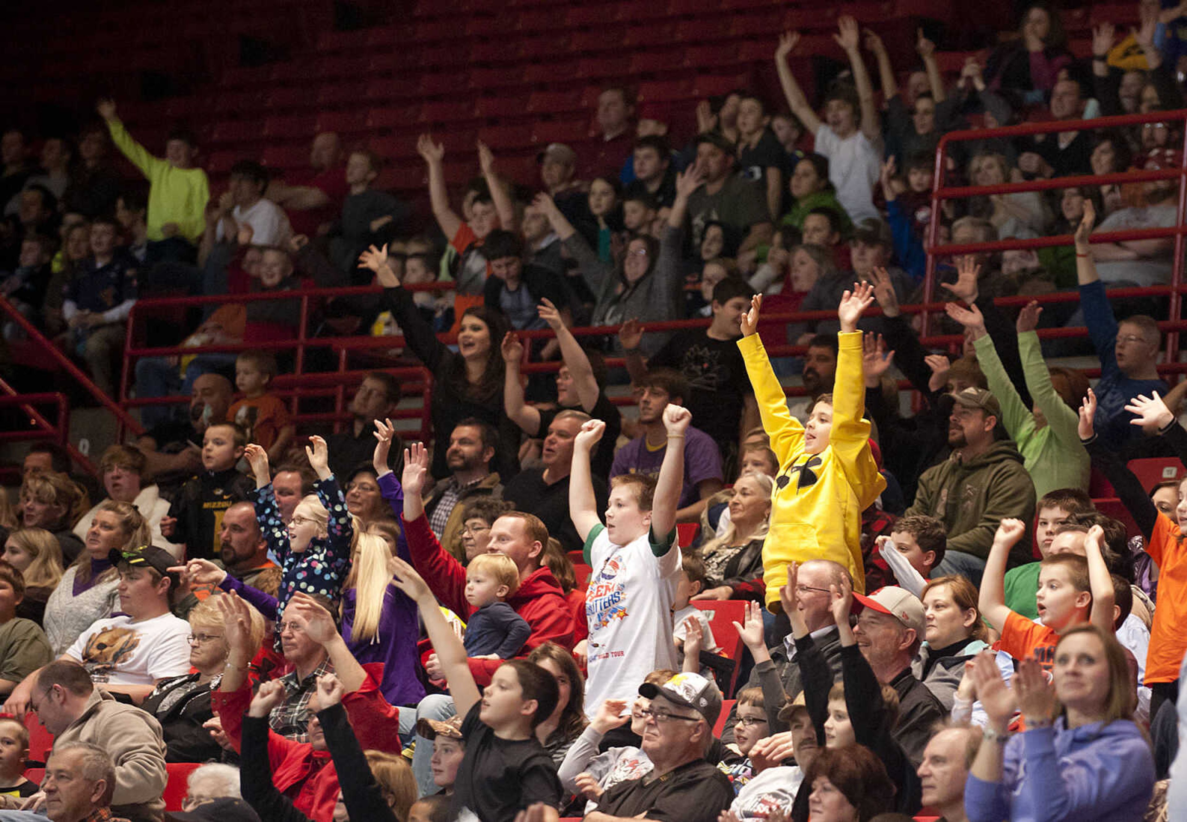 Fans cheer as souvenirs are tossed into the crowd during the Original Harlem Globetrotters' performance Monday, Jan. 13, at the Show Me Center.