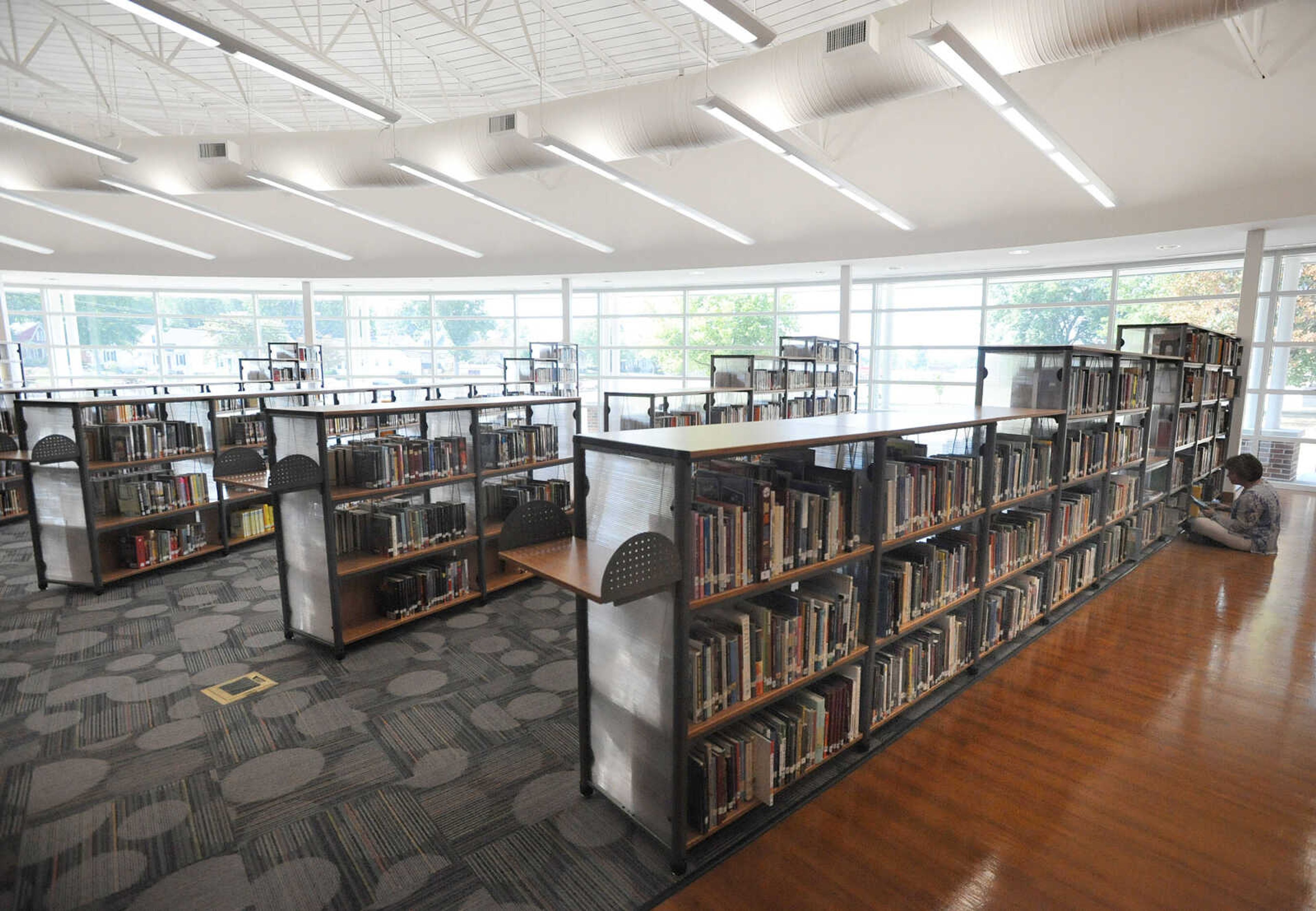 LAURA SIMON ~ lsimon@semissourian.com
Central Junior High School library assistant Becky Decker nears the end of the last stack of books Thursday morning, Aug. 16, 2012. The new 8300 sq. foot library's design mimics that of an open book as you enter. The library also features a computer lab, classroom space and homework stations.