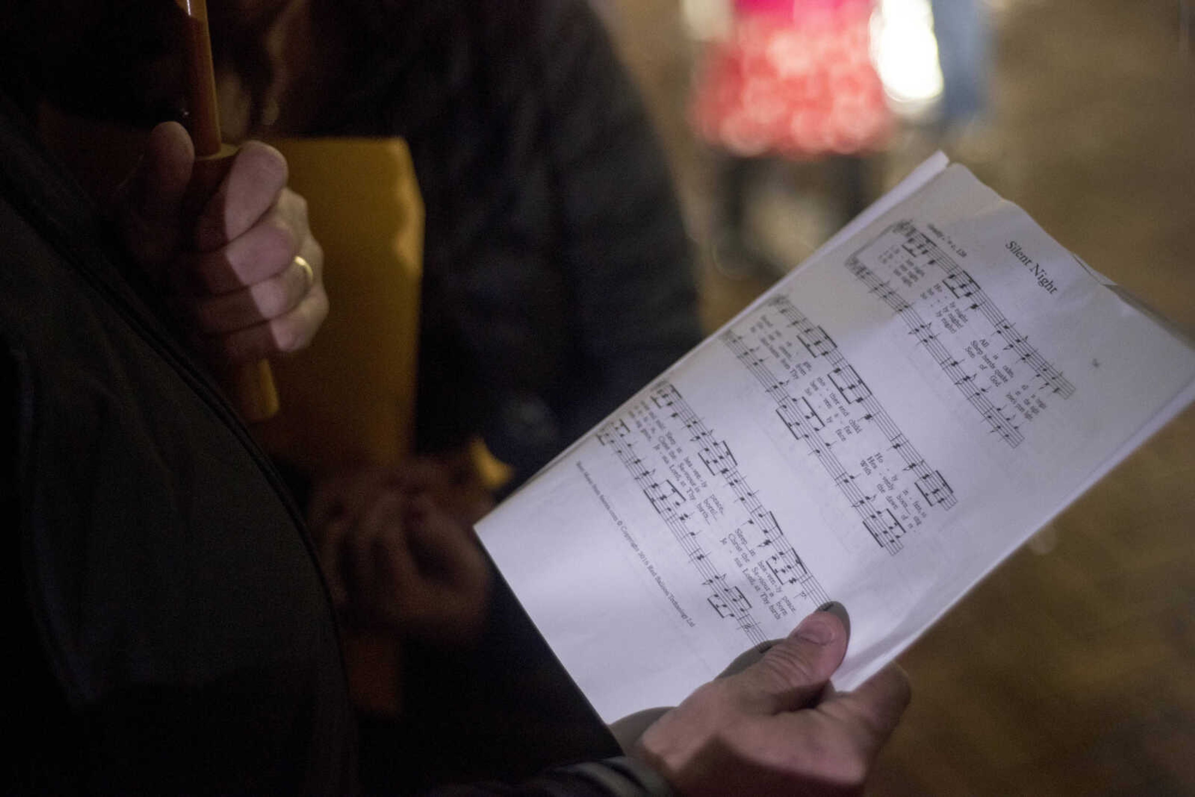 Alan Bruns holds sheet music during the inaugural Christmas tree lighting hosted by Old Town Cape Friday, Nov. 29, 2019, at the Vasterling Suites in Cape Girardeau.