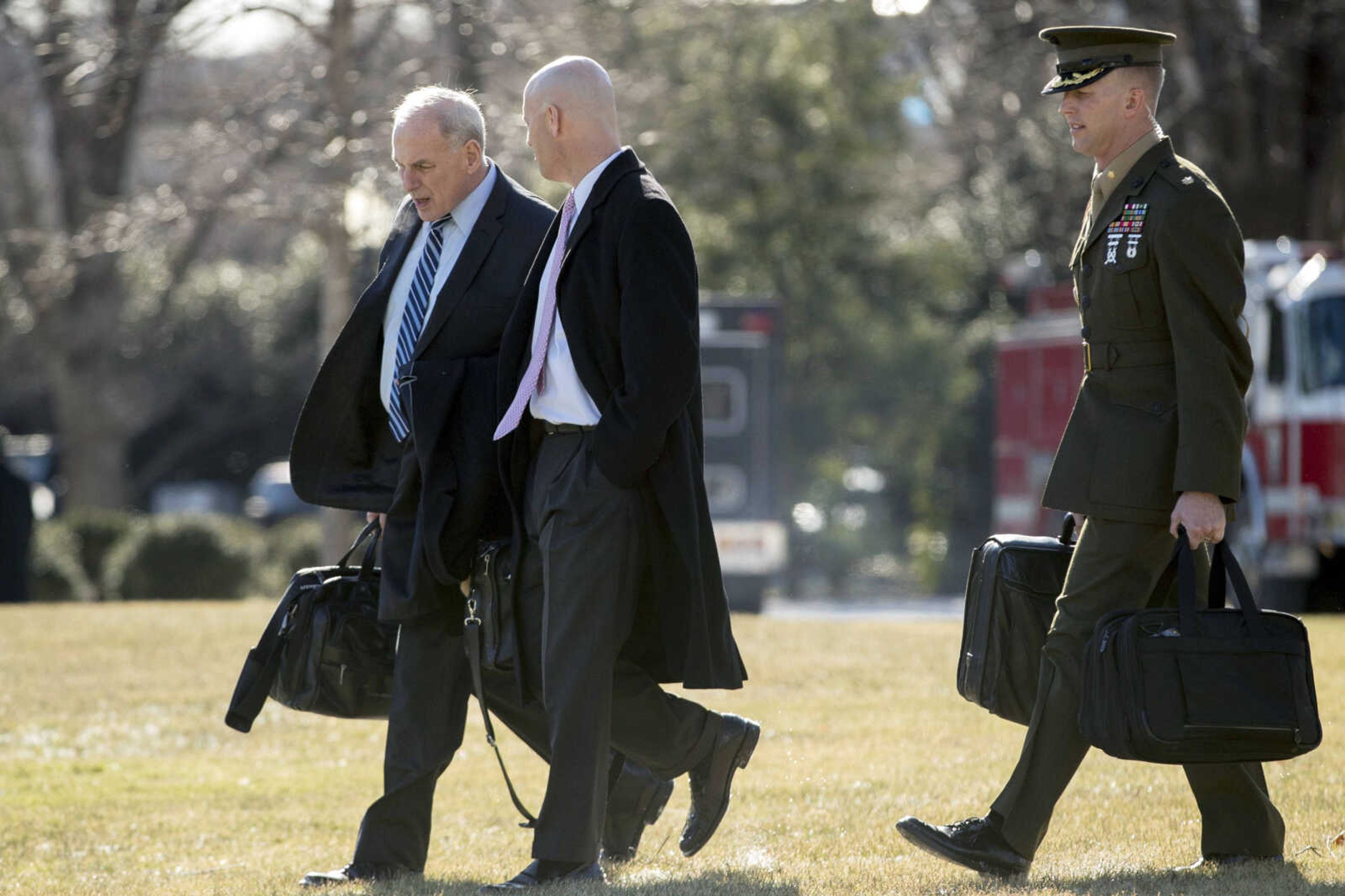 President Donald Trump's chief of staff, John Kelly, left, and White House director of legislative affairs Marc Short, second from left, walk toward Marine One on the South Lawn of the White House on Friday in Washington.<br>to travel with President Donald Trump to Camp David in Maryland.