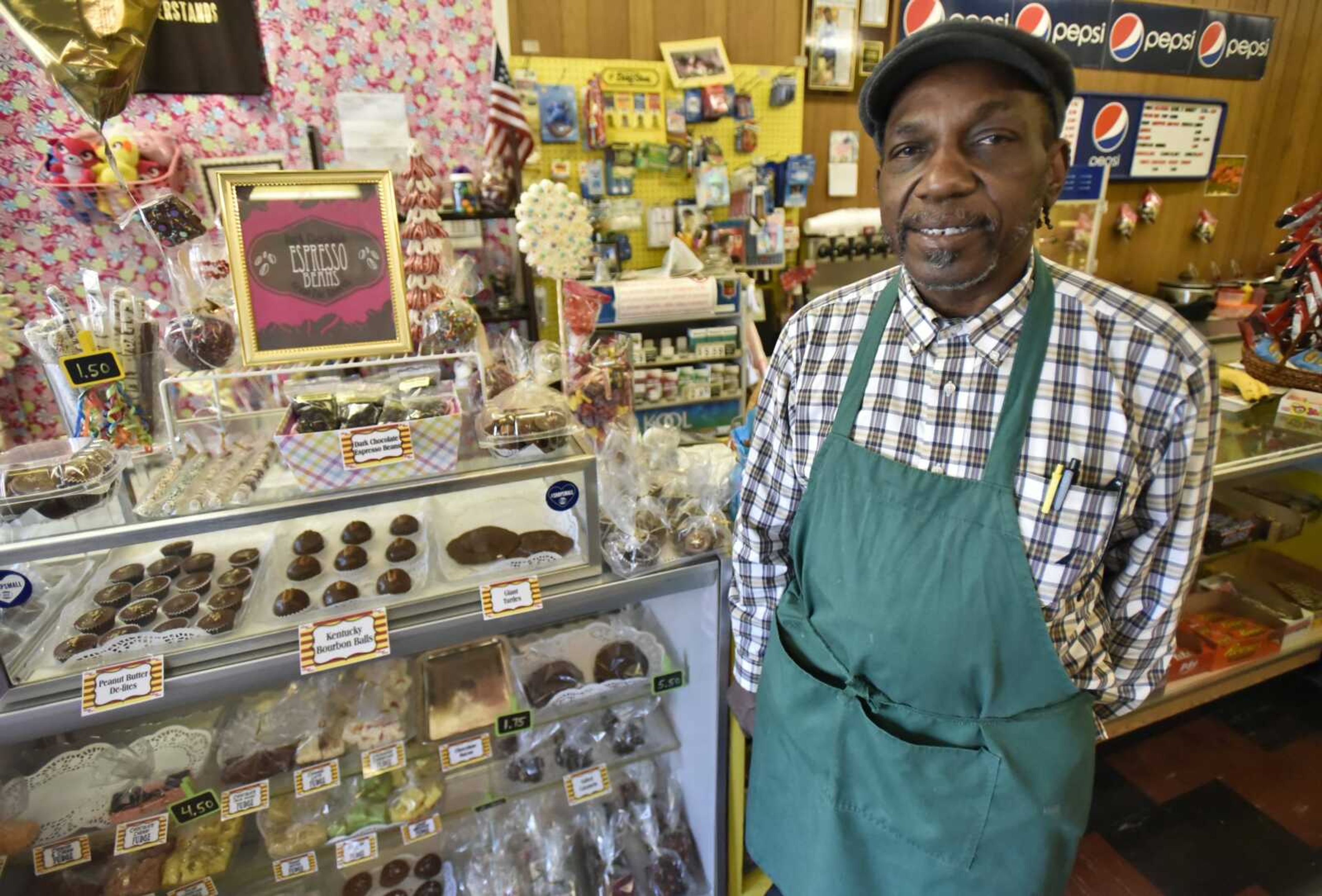 Robert Gentry stands with a display of gourmet chocolates at Corner Grocery Store in Cape Girardeau.