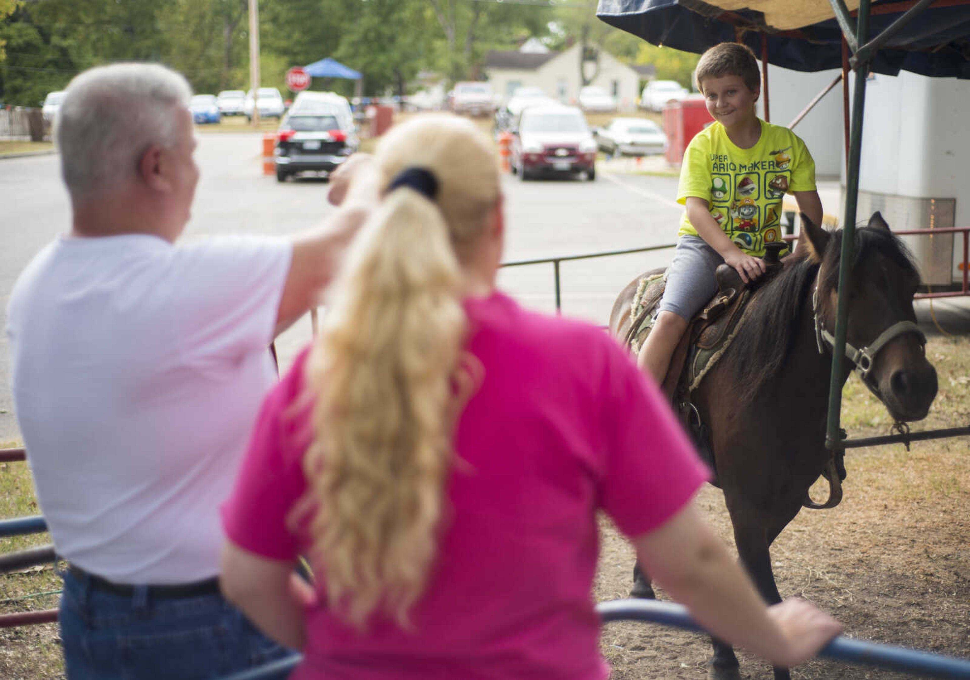 From left, Jeff and Viki Cook watch their son J.D. ride a pony at the SEMO District Fair on September 11, 2017, in Cape Girardeau.