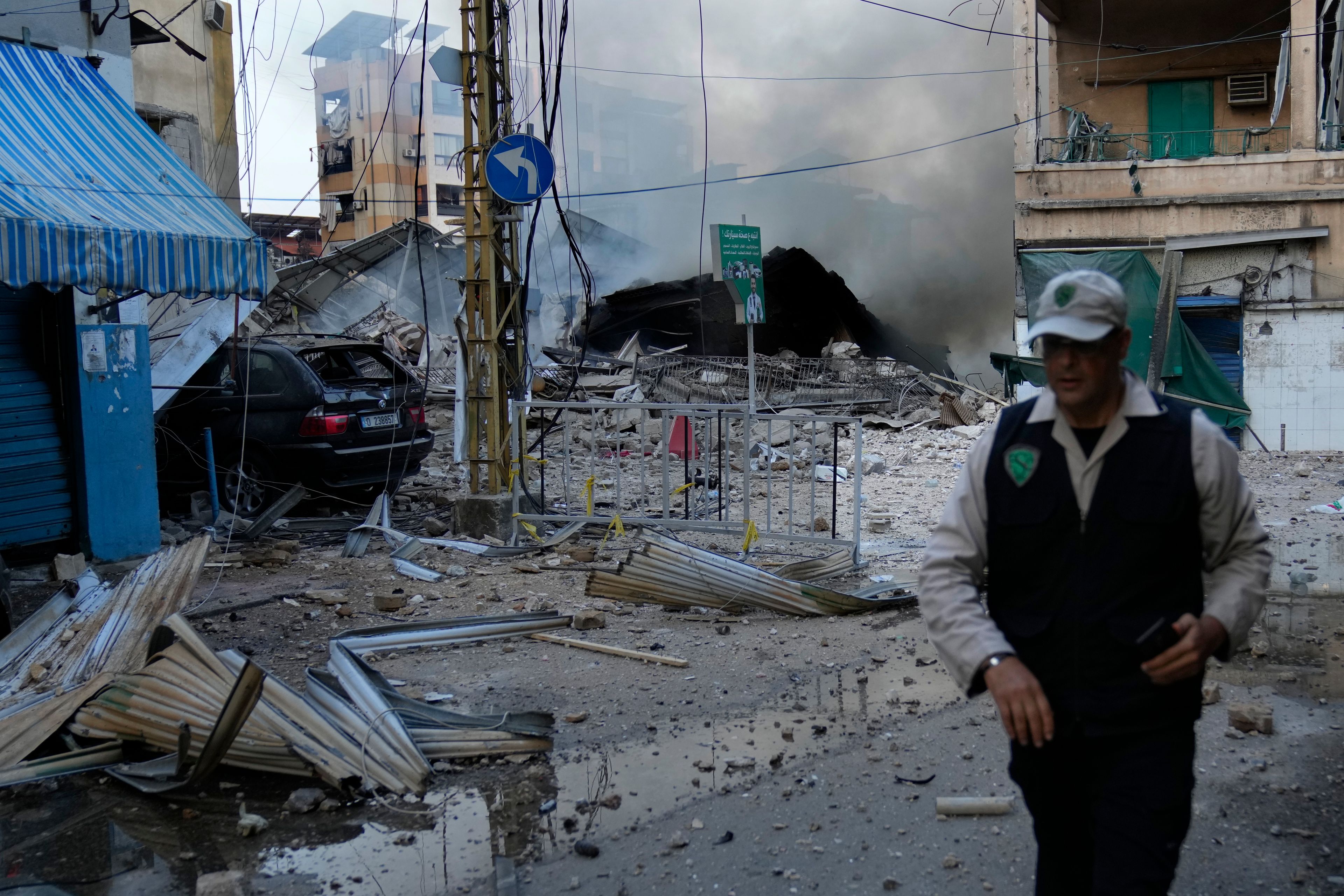 A man leaves a street after he saw the building where he was living and destroyed by Israeli airstrike in Dahiyeh, Beirut, Lebanon, Sunday, Oct. 6, 2024. (AP Photo/Hussein Malla)