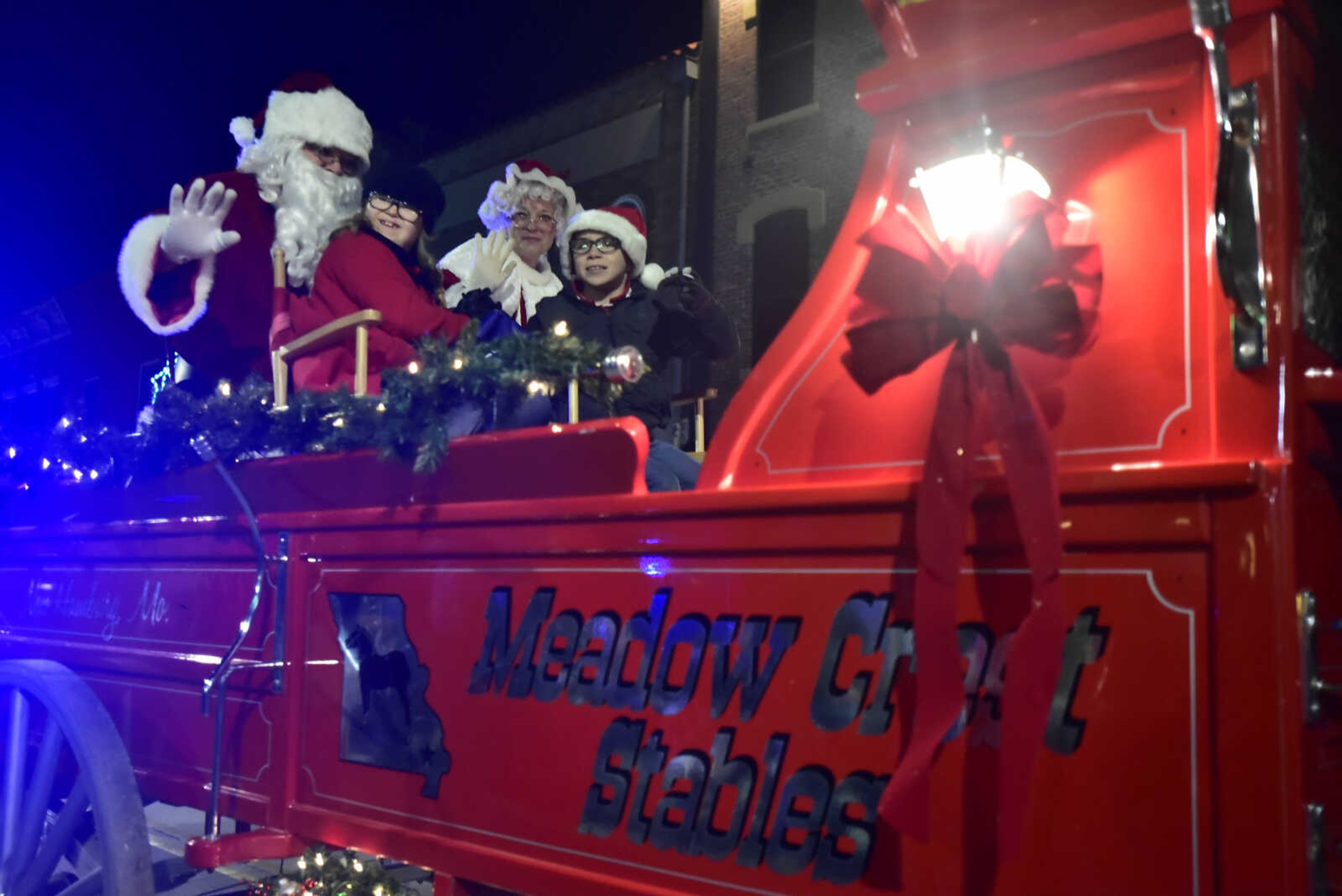 Santa Claus and Mrs. Claus wave to children and toss candy canes to children at the 26th annual Parade of Lights Nov. 26, 2017, in Cape Girardeau.