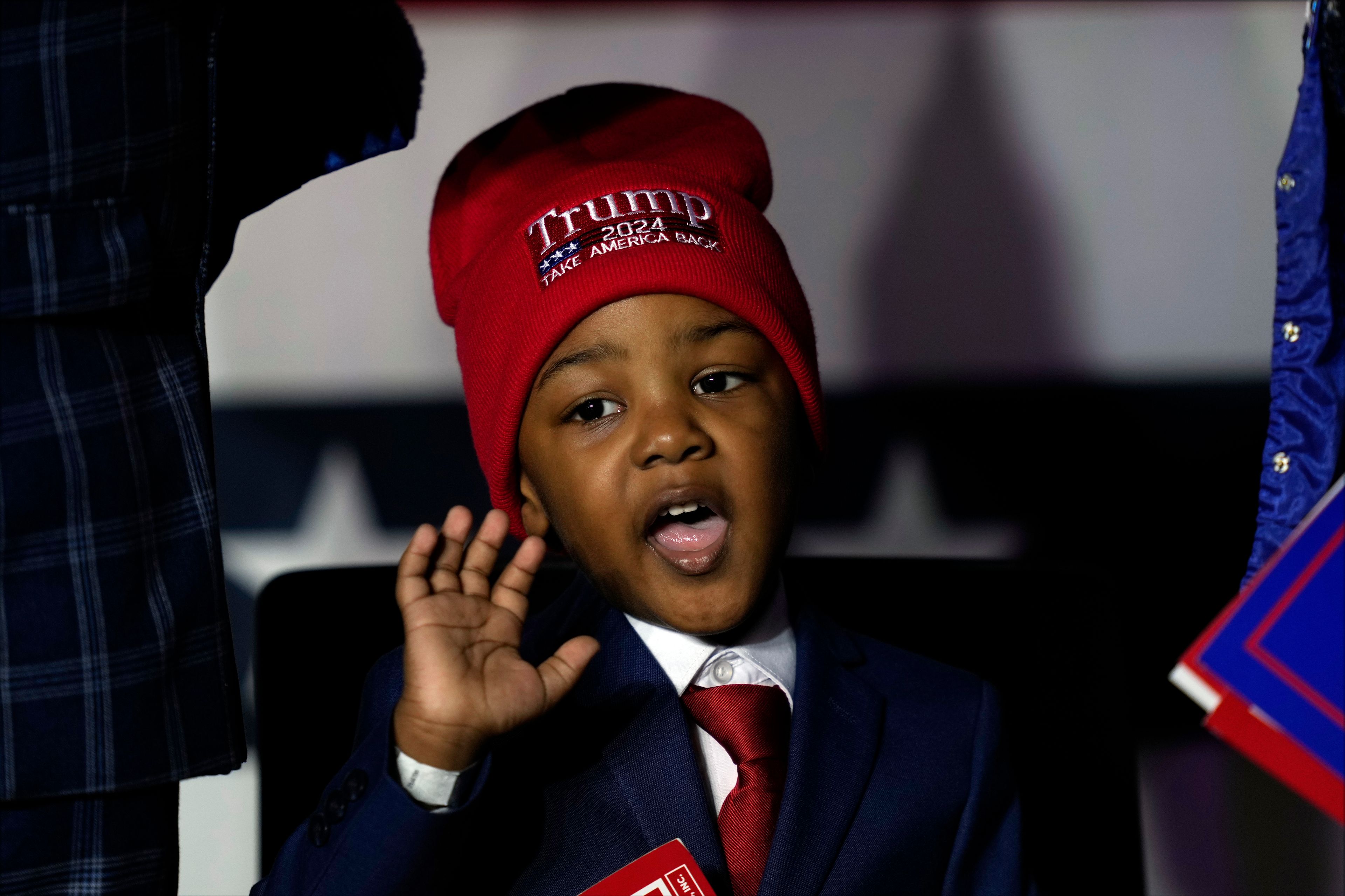 A child waves after Republican presidential nominee former President Donald Trump spoke at a campaign rally at Williams Arena at Mignes Coliseum, Monday, Oct. 21, 2024, in Greenville, N.C. (AP Photo/Julia Demaree Nikhinson)