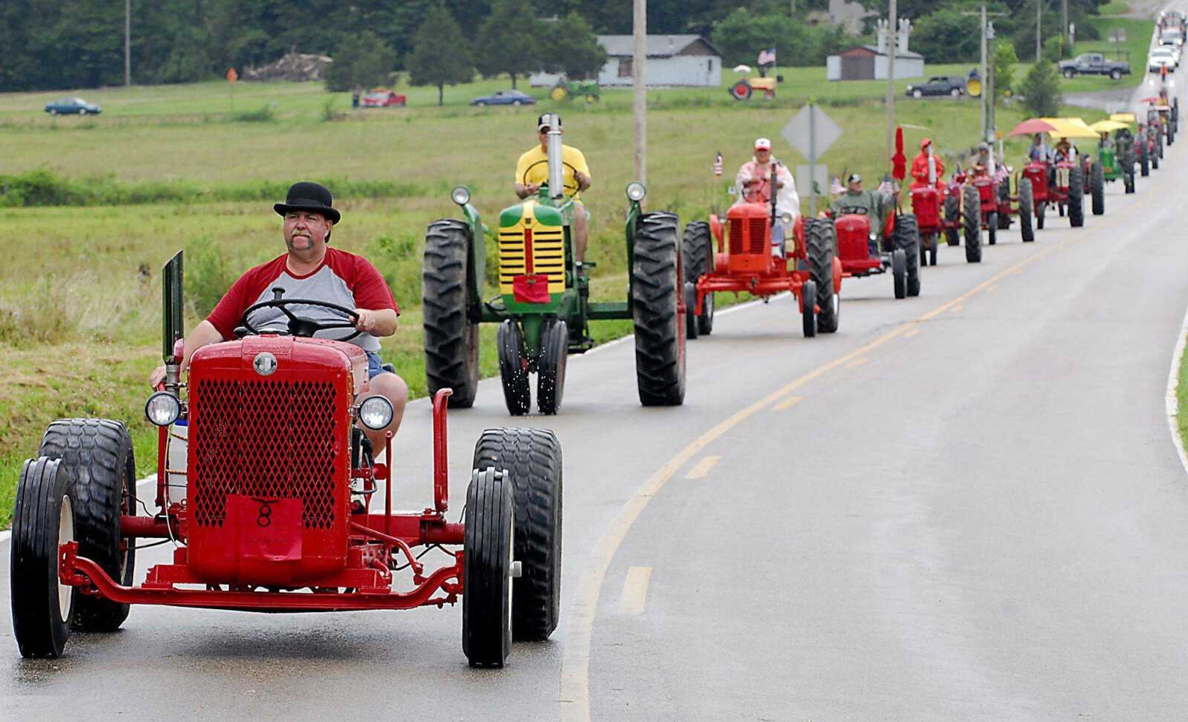 David Steinnerd of Jackson drives an early 1940s Red Seal tractor Saturday along Route T during the annual antique tractor ride near Perryville, Mo. (Kit Doyle)