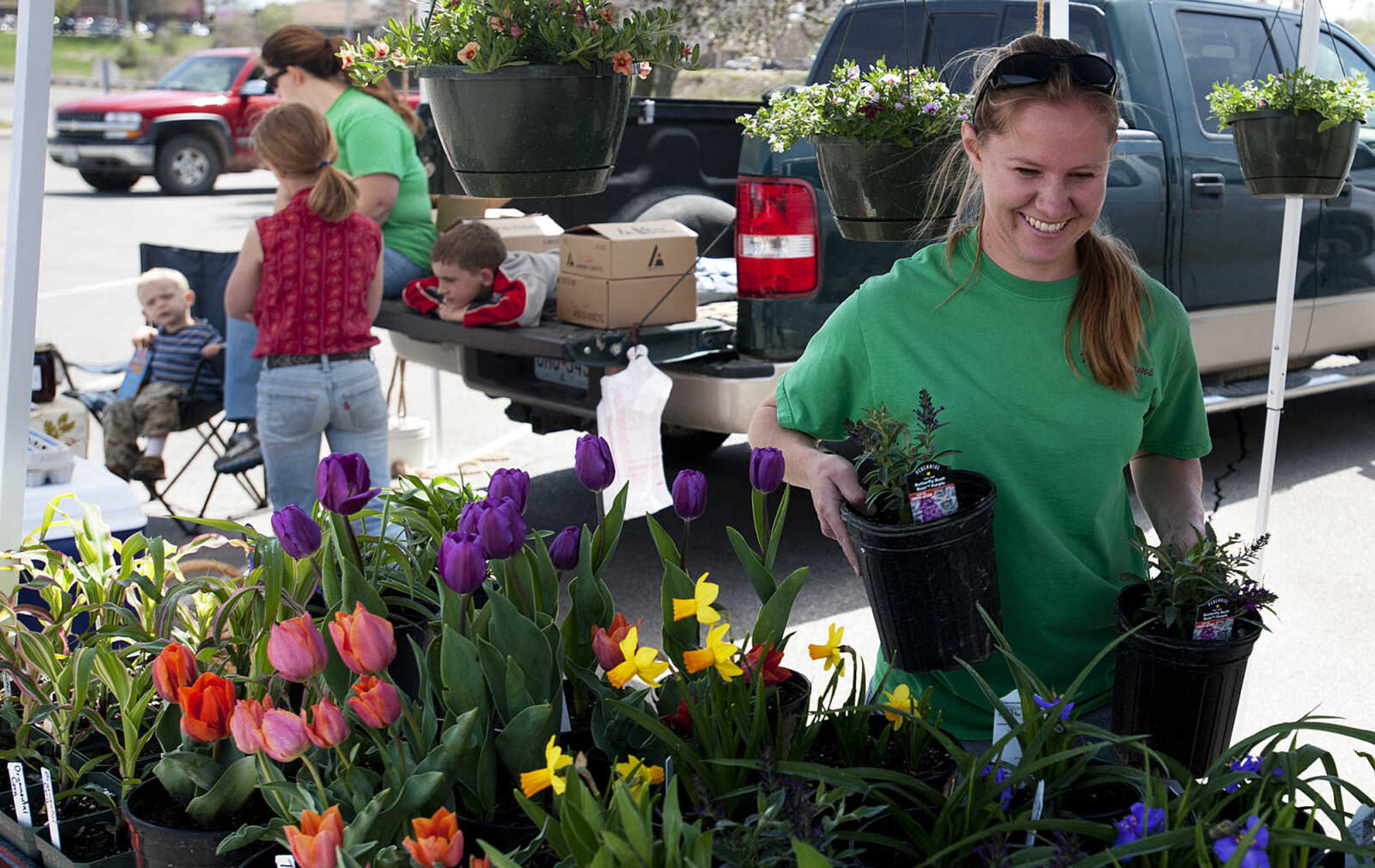 Karen Null, of Marbel Hill, Mo., arranges flowers in the Null Farms Produce booth on the first day of the Cape Farmer's Market Thursday, April 17, at West Park Mall in Cape Girardeau. The market is open from 12:00 p.m. to 5 p.m. on Thursdays and is located in the mall's east parking lot which is accessible from the Mt. Auburn Road entrance.