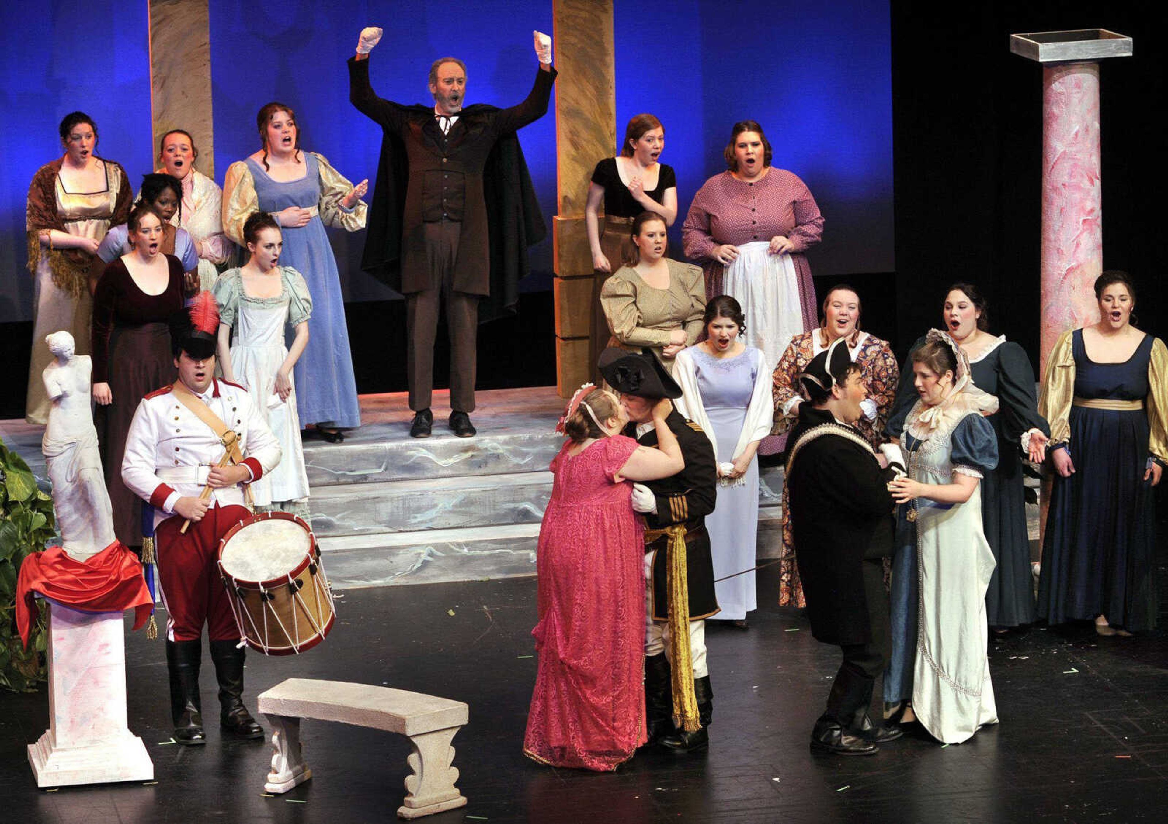 Students in the fall semester Opera Workshop class at Southeast Missouri State University perform Mozart's comic opera "Cosi fan Tutte" Sunday, Jan. 22, 2012 at Bedell Performance Hall. In this scene, the ensemble of townspeople and servants of London bid two officers who are friends of Don Alfonso, with arms raised, an aged cynic played by Timothy Schmidt, adieu in anticipation of great military triumphs. Fiordiligi, played by Megan Statler, kisses her fiance, Guglielmo, played by Adam J. Bradt, while Ferrando, played by Aaron Lerma, says goodbye to his fiancee, Dorabella, played by Katherine Shay. The opera was first performed in Vienna in 1790. The local production was repositioned from 1750s Italy to England, circa 1800. (Fred Lynch)