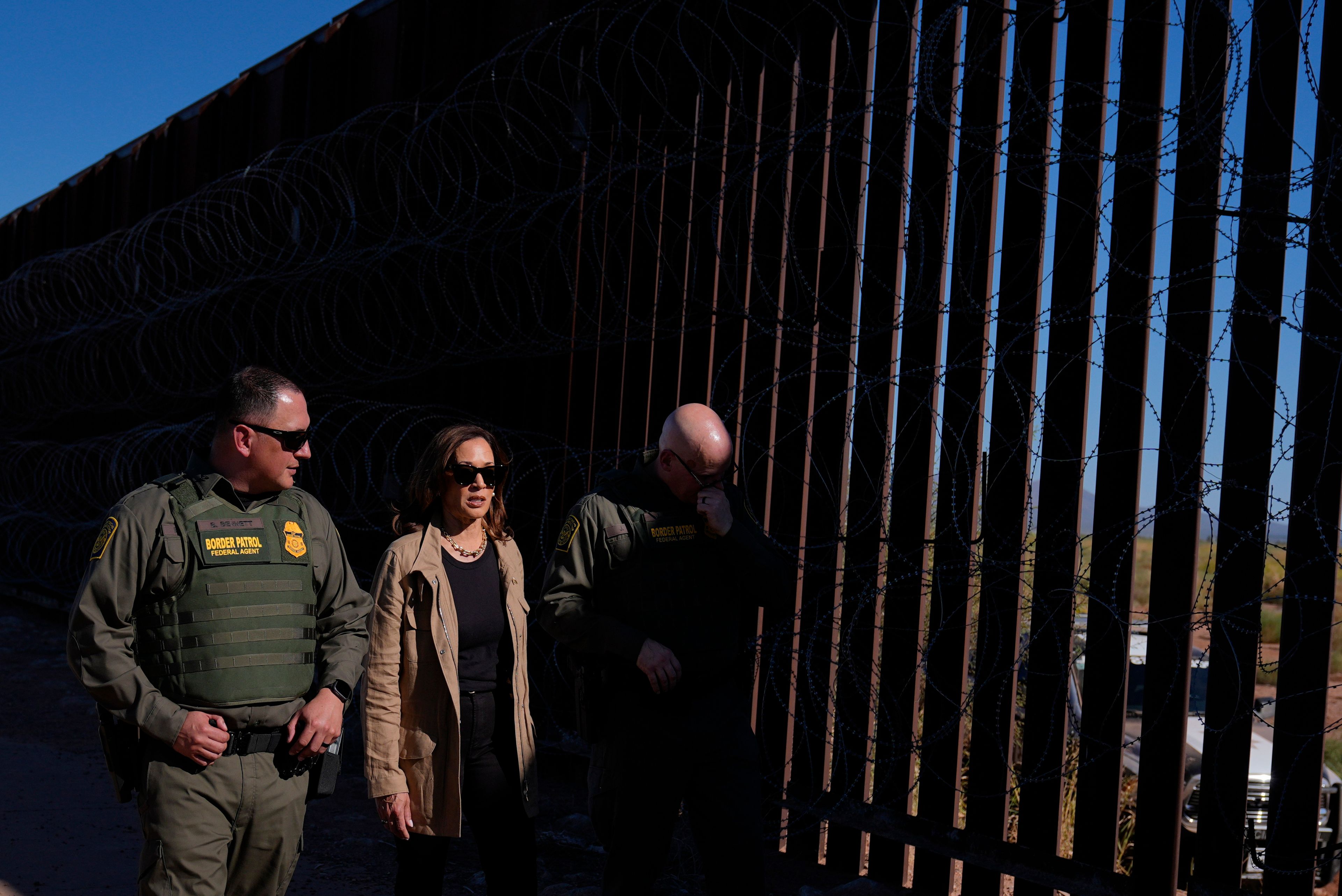 Democratic presidential nominee Vice President Kamala Harris talks with John Modlin, the chief patrol agent for the Tucson Sector of the U.S. Border Patrol, right, and Blaine Bennett, the U.S. Border Patrol Douglas Station border patrol agent in charge, as she visits the U.S. border with Mexico in Douglas, Ariz., Friday, Sept. 27, 2024. (AP Photo/Carolyn Kaster)