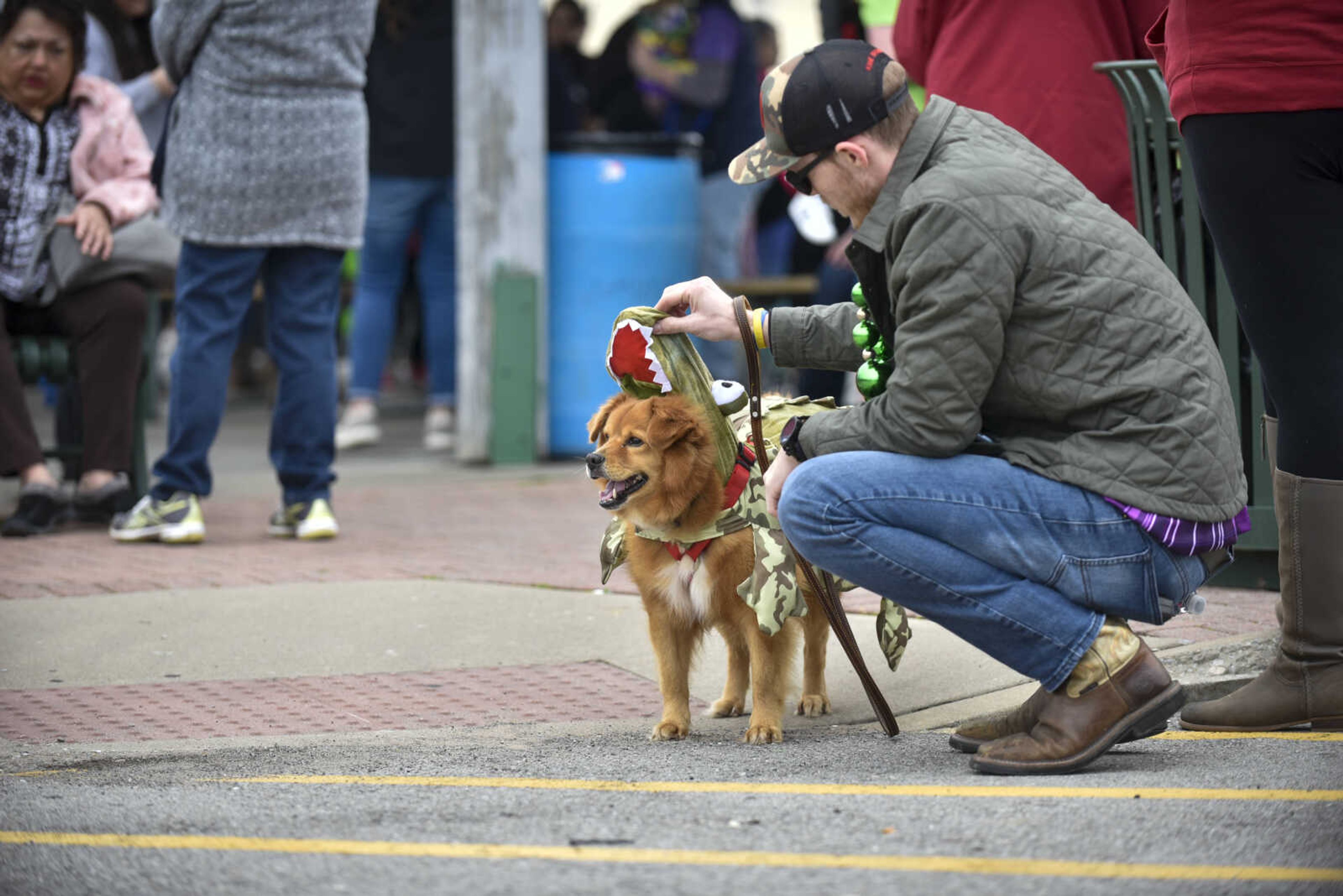 Brett Little adjusts the hood of his rescued dog, Raymond, before the start of the 2nd annual Mardi Paws Parade of Pets on Sunday, March 18, 2018, in Cape Girardeau.