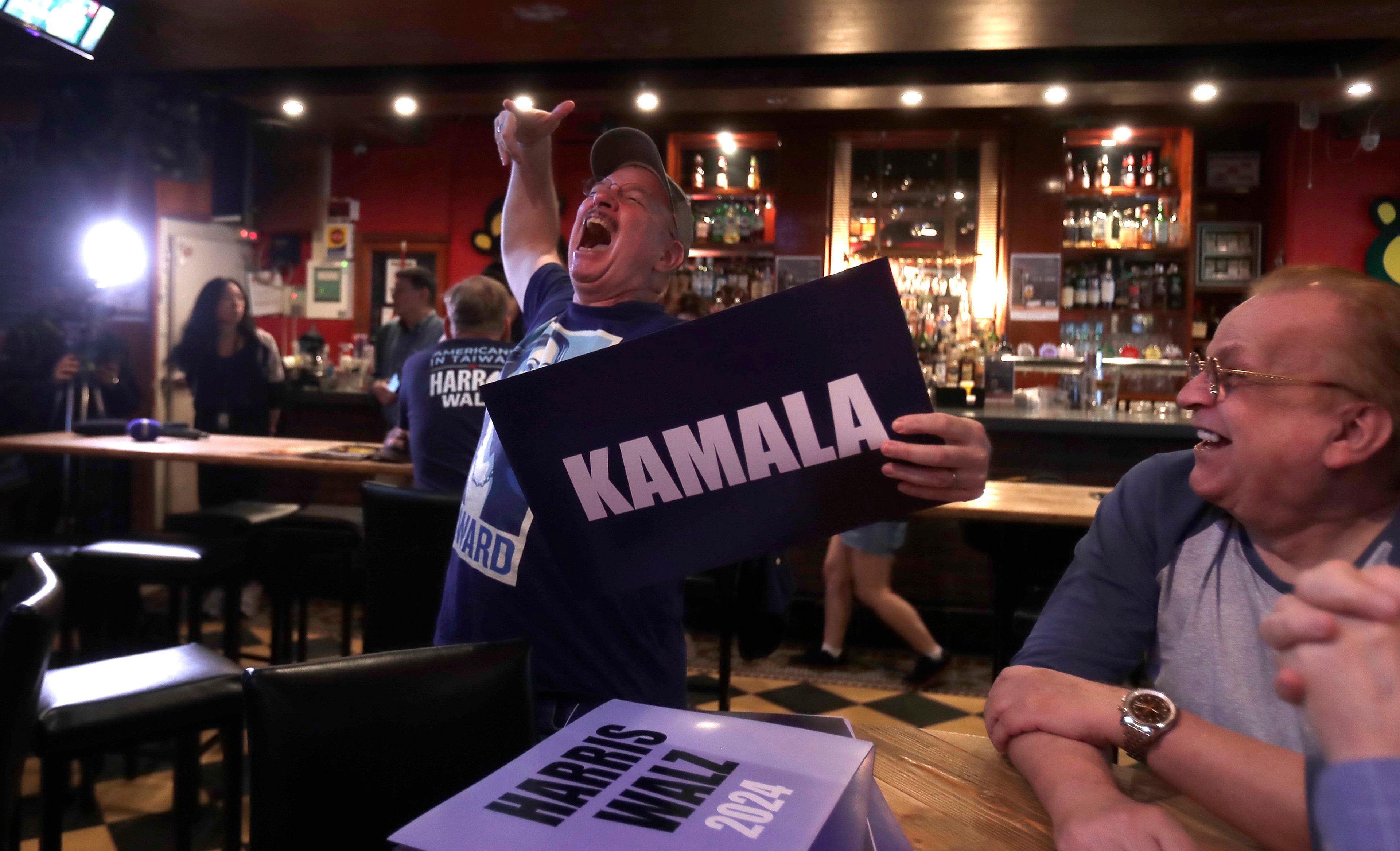 A supporter of Democratic presidential nominee Vice President Kamala Harris reacts as they watch televised reports for the 2024 U.S. presidential election during a watch party in Taipei, Taiwan, Wednesday, Nov. 6, 2024. (AP Photo/Chiang Ying-ying)