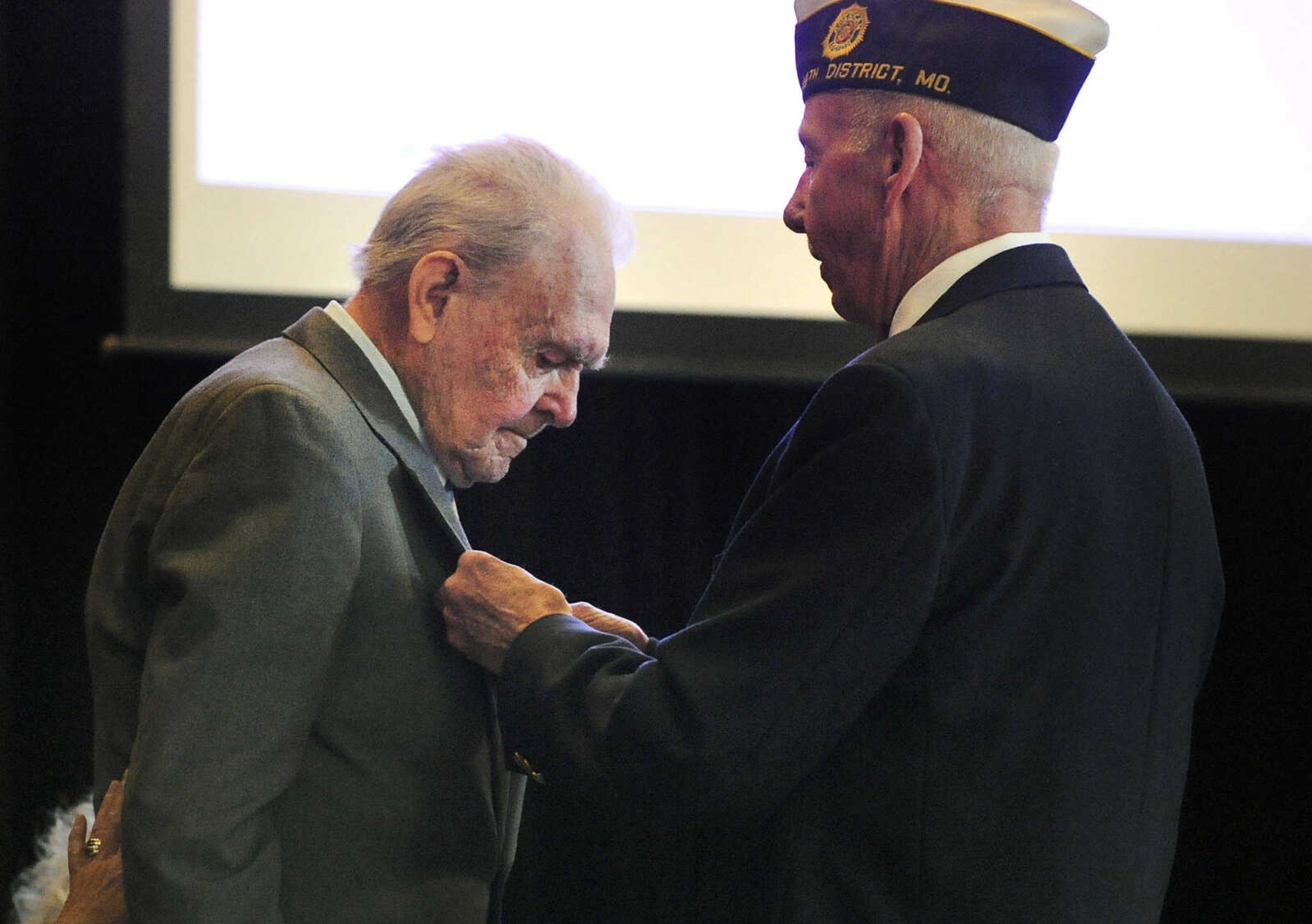 LAURA SIMON ~ lsimon@semissourian.com

Tom Giles, member of American Legion Post 63 color guard, right, presents U.S. Army Air Corps veteran Sgt. Clifford Heinrich with a medal on Monday, March 21, 2016, at Alma Schrader Elementary in Cape Girardeau. Heinrich was also presented with an American Campaign Medal, WWII Victory Medal, Army Good Conduct Medal, a WWII Lapel Button, European-African-Middle Eastern Campaign Medal and the Purple Heart for his service during WWII. Pictured with Heinrich are Diane Gomersall, left, and Linda Thompson.