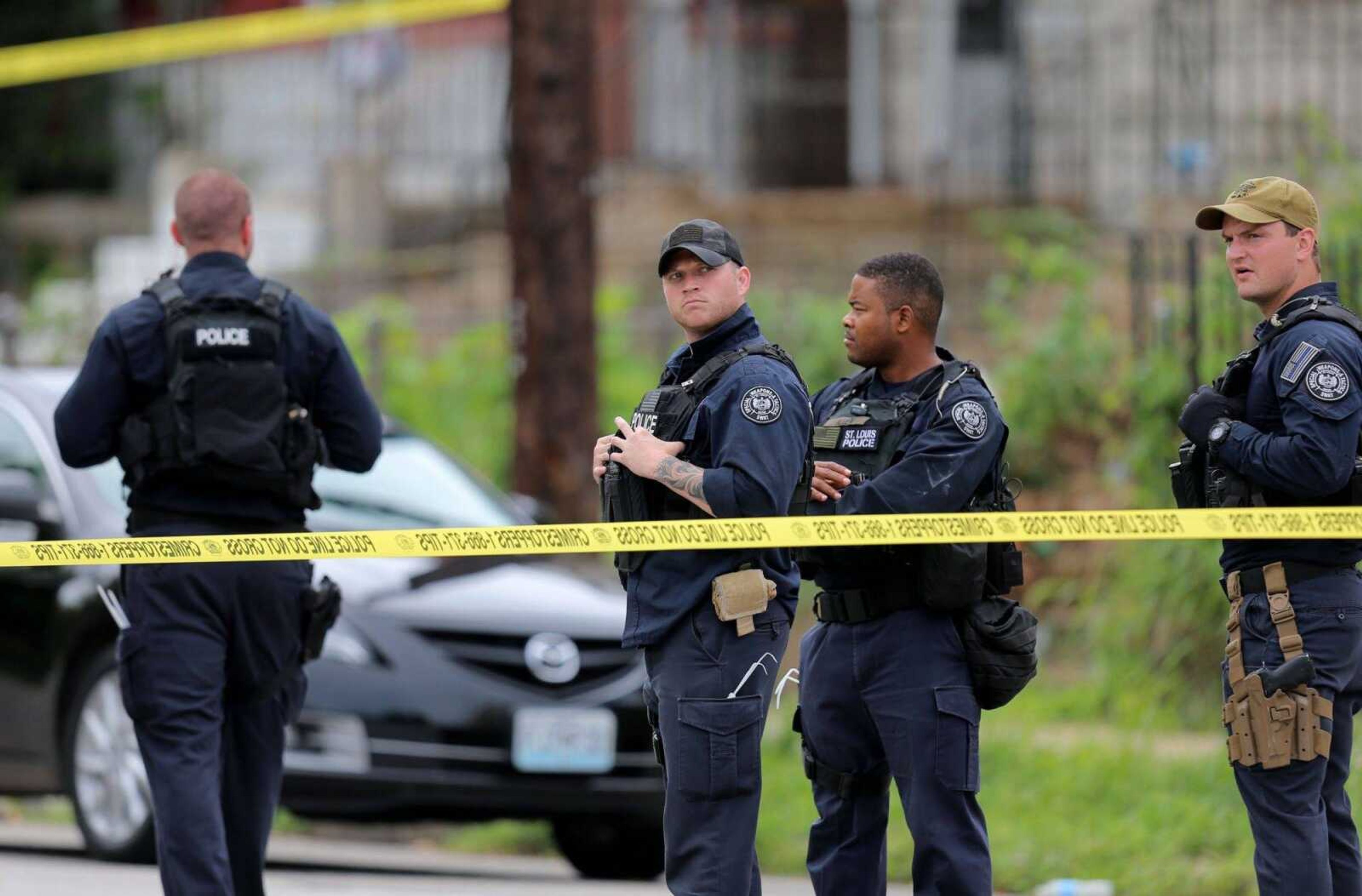 St. Louis police gather at the scene of a fatal officer-involved shooting Aug. 19 where police sought to execute a search warrant at a home in St. Louis. In a violent year in St. Louis, a theme has emerged: The gun used in the crime was probably stolen. Gun theft reports are up nearly 70 percent. (David Carson ~ St. Louis Post-Dispatch)