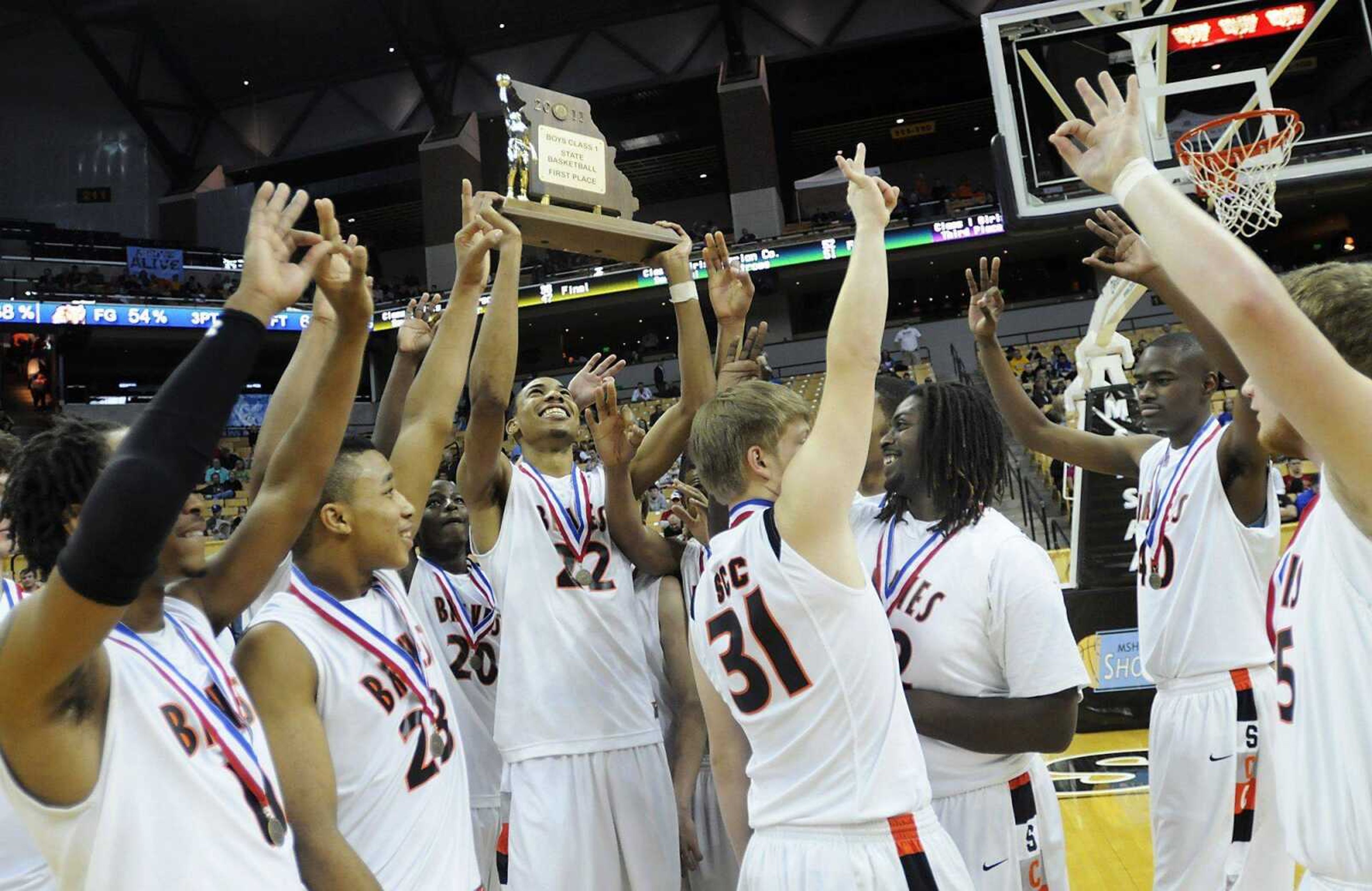 Otto Porter holds up the Class 1 championship trophy as Scott County Central players celebrate their 69-54 victory against Dadeville in the state final Saturday at Mizzou Arena in Columbia, Mo. The title was the third straight for the Braves, who have 15 state championships overall. (Kristin Eberts)