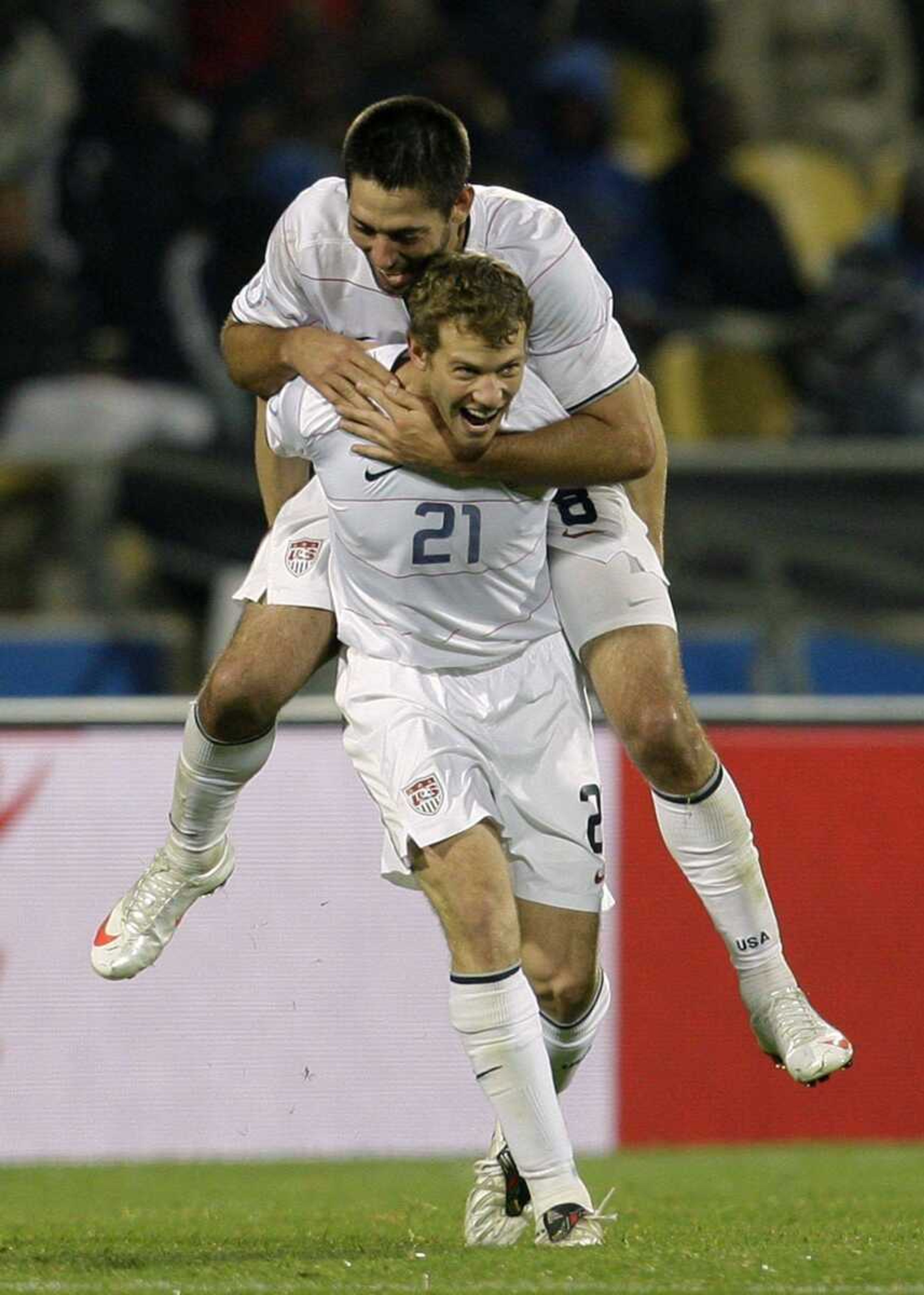 USA's Clint Dempsey is carried by teammate Jonathan Spector after scoring the third goal against Egypt in their Confederations Cup Group B match Sunday in Rustenburg, South Africa. (PAUL THOMAS ~ Associated Press)