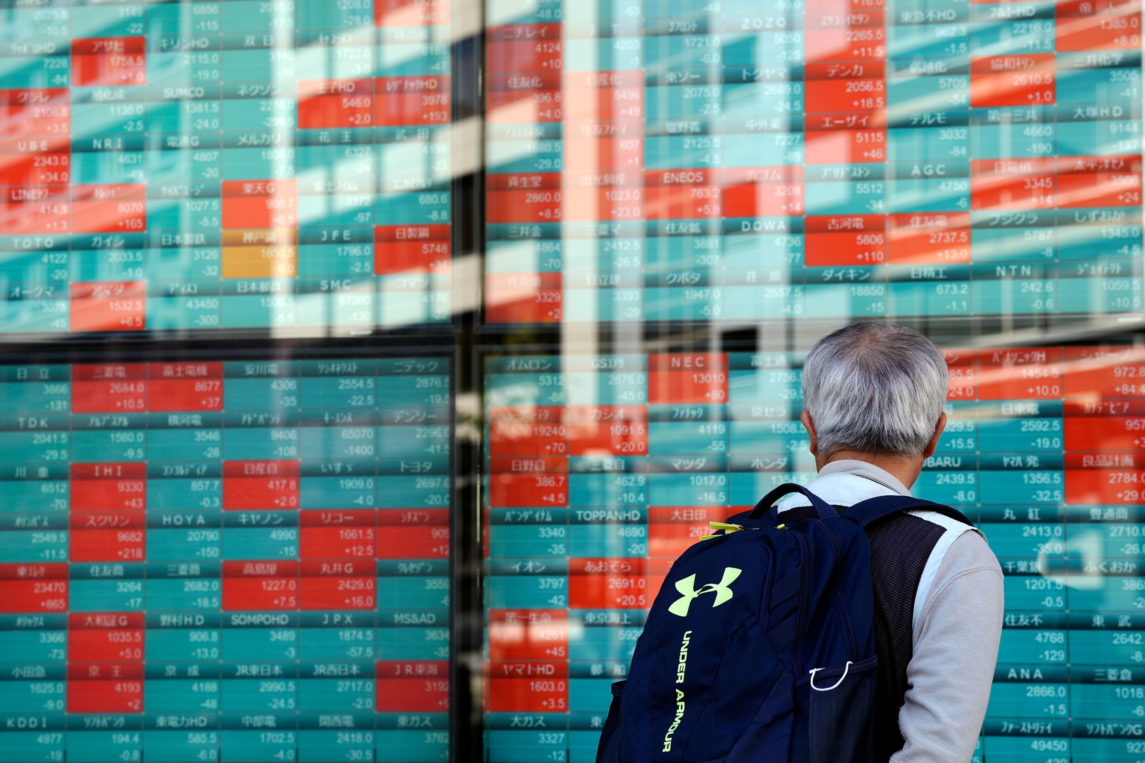 A person looks at an electronic stock board showing Japan's Nikkei index at a securities firm Wednesday, Nov. 13, 2024, in Tokyo. (AP Photo/Eugene Hoshiko)