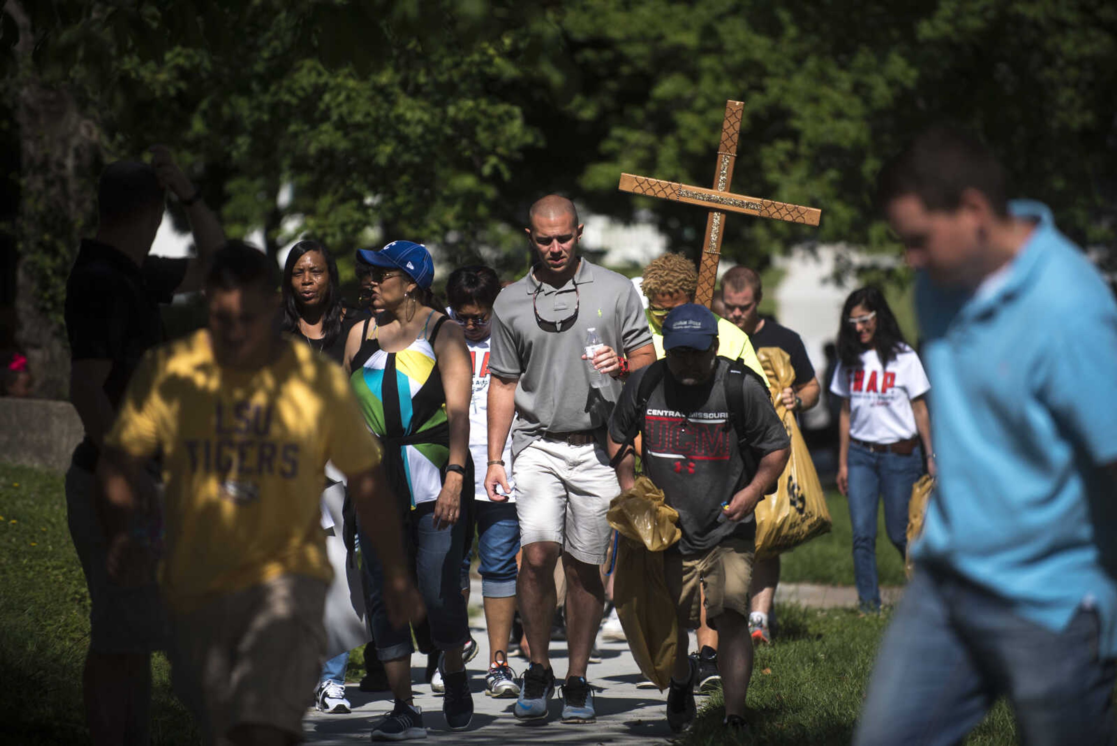 Community Members march during a Stop Needless Acts of Violence Please (SNAP) prayer march Saturday, June 10, 2017 in Cape Girardeau.