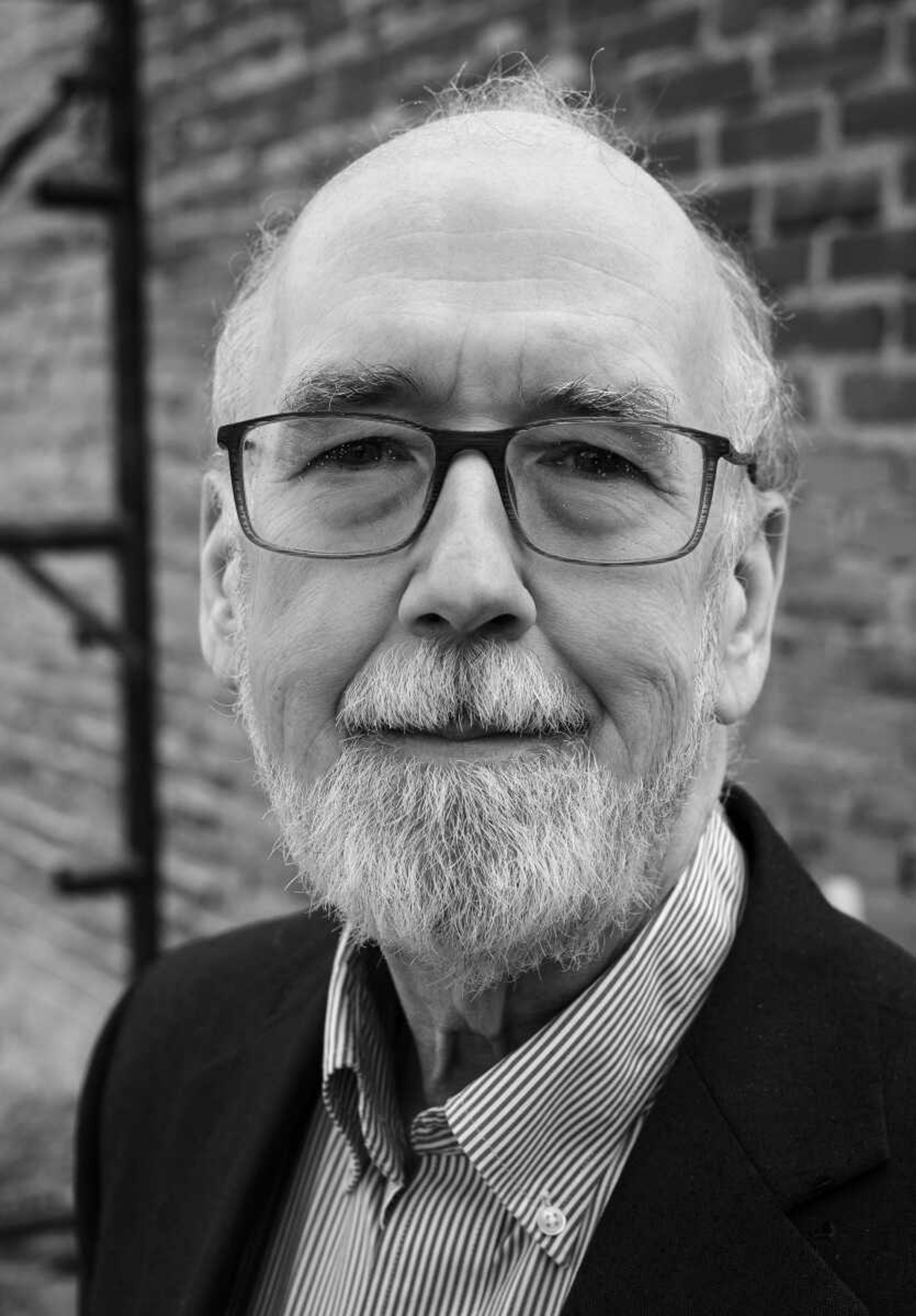 Dr. Steven Hoffman, a professor and coordinator of the historic preservation program at Southeast Missouri State University, stands near the Broadway Theater as renovations continue on the historic building.