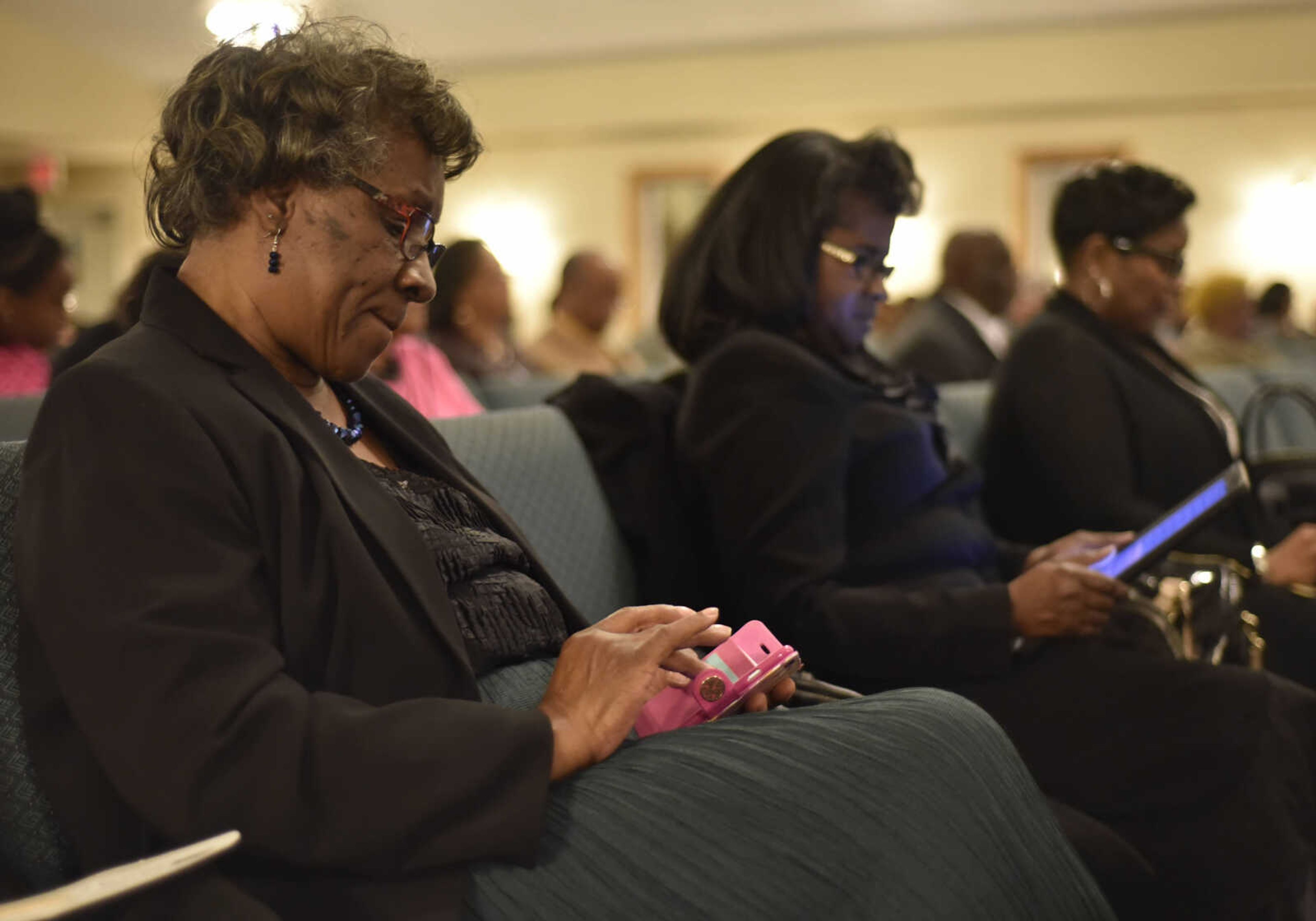 BEN MATTHEWS ~ bmatthews@semissourian.com&nbsp;Attendees at the 27th Annual Dr. Martin Luther King, Jr. Community Celebration Program listen to a scripture reading while following along with digital editions of the Bible on January 15, 2017 at Greater Dimensions Church in Cape Girardeau.