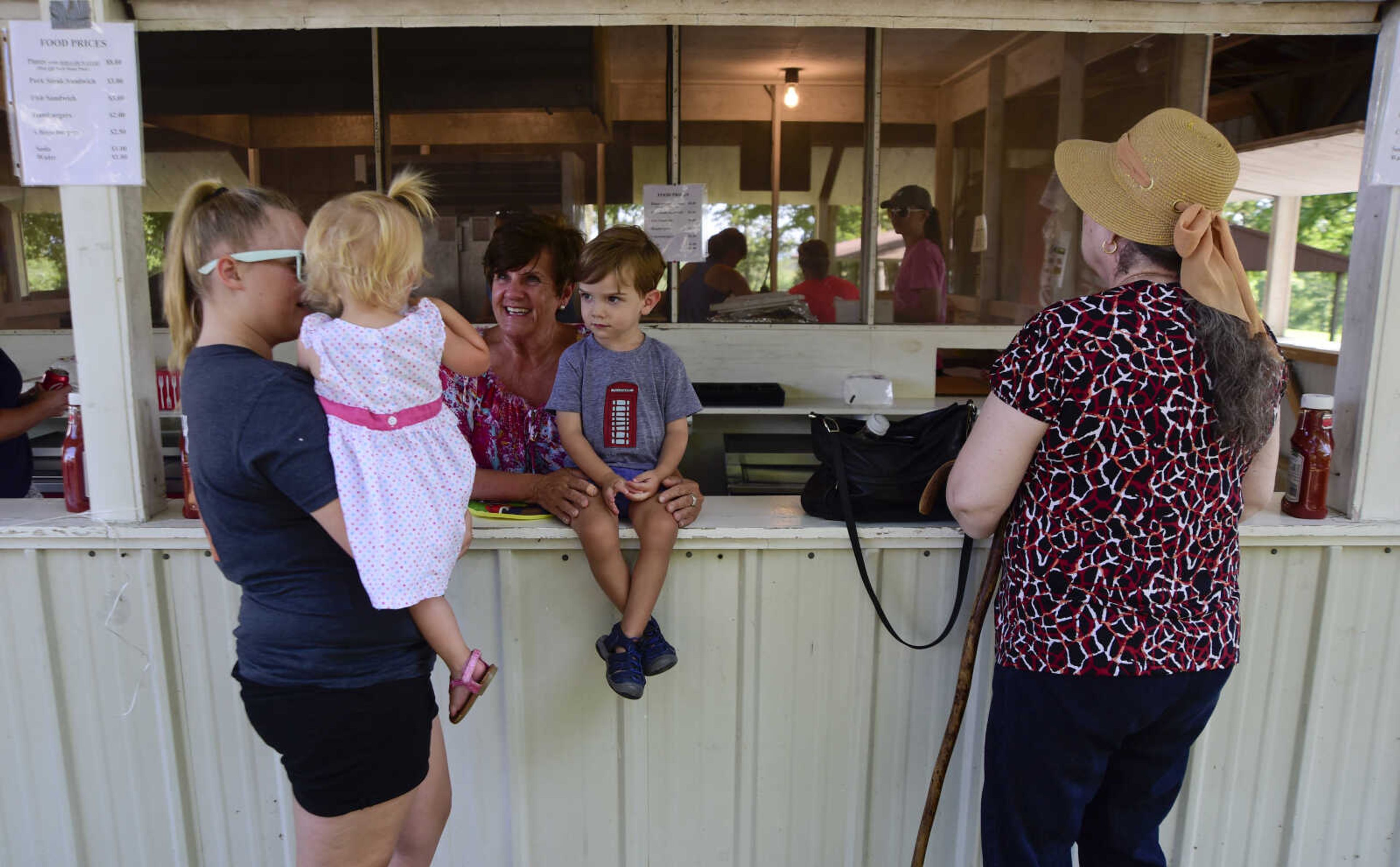 People wait in line for food at the Trinity Church Picnic Sunday, July 16, 2017 at the Altenburg Fairgrounds.