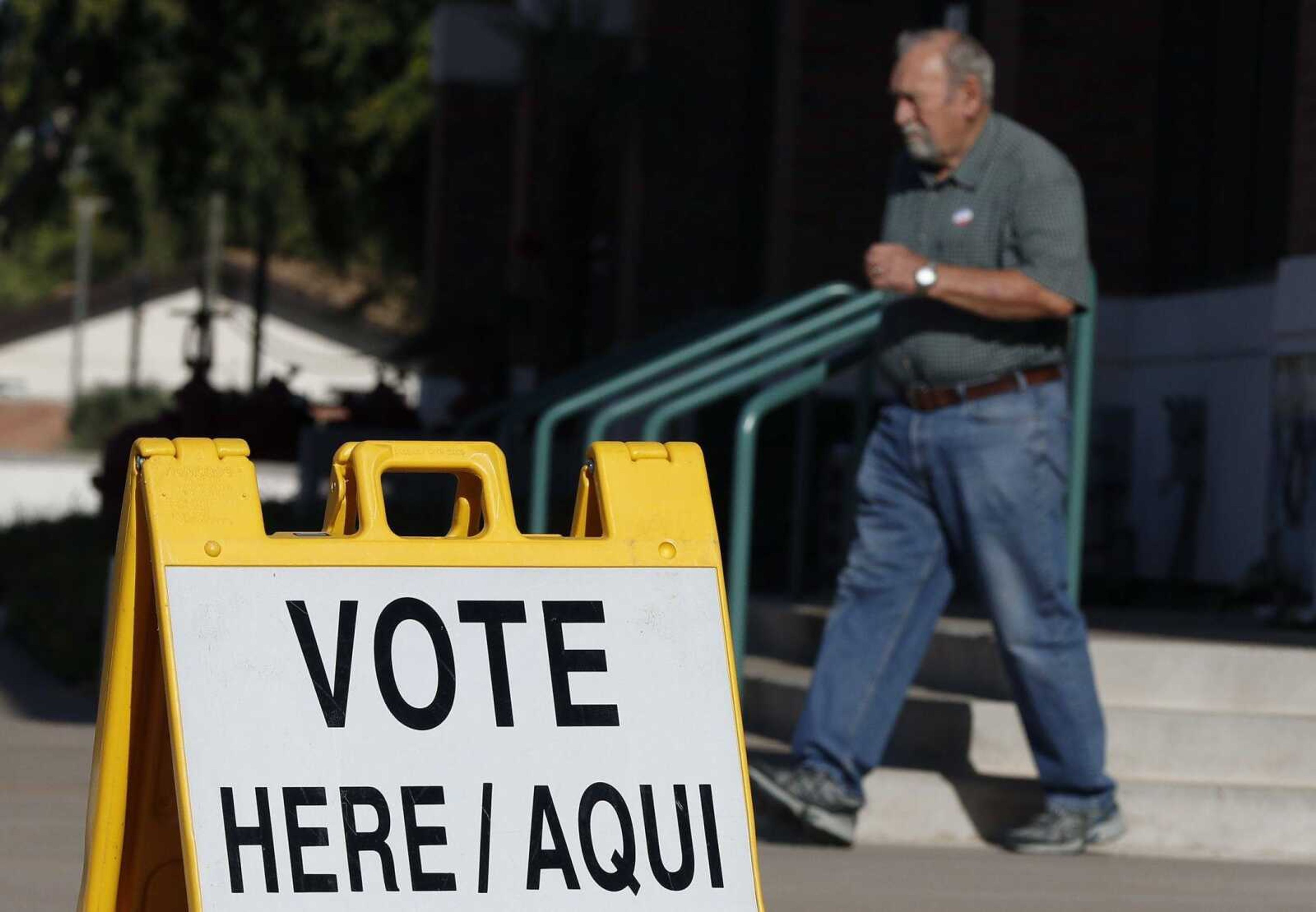 A man exits his polling station for voting in the Arizona primary Tuesday in Tempe.