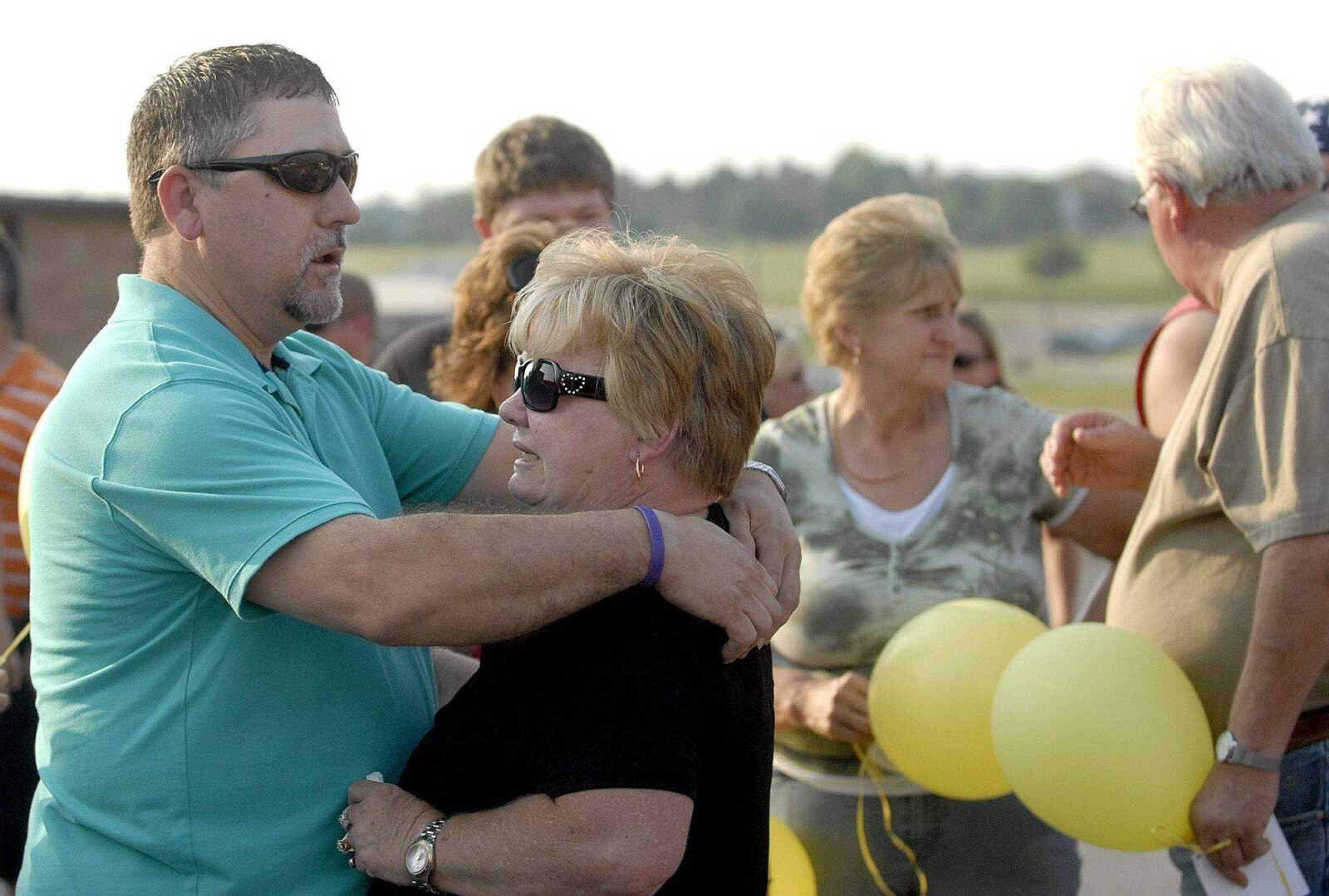 Dexter Pirtle consoles Ruby Rawson on Thursday during a prayer service for Rawson's daughter, Jacque Sue Waller, at Farmington High School. Waller, 39, was last seen June 1 in Jackson. (Laura Simon)