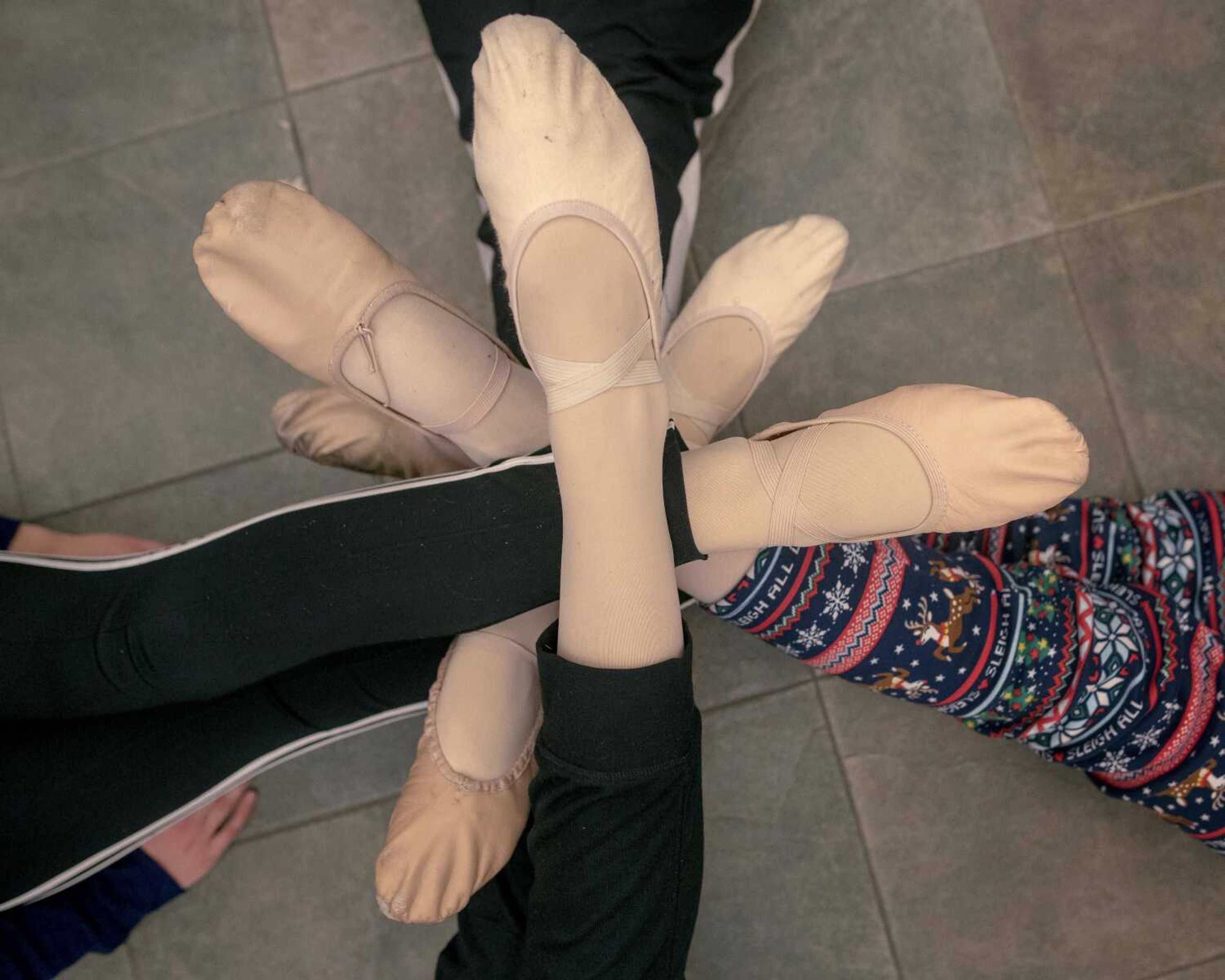 Dancers' ballet shoes are seen during a stretching exercise before performing with the Moscow Ballet on Tuesday, Dec. 10, 2019, at the Southeast Missouri State University River Campus in Cape Girardeau.