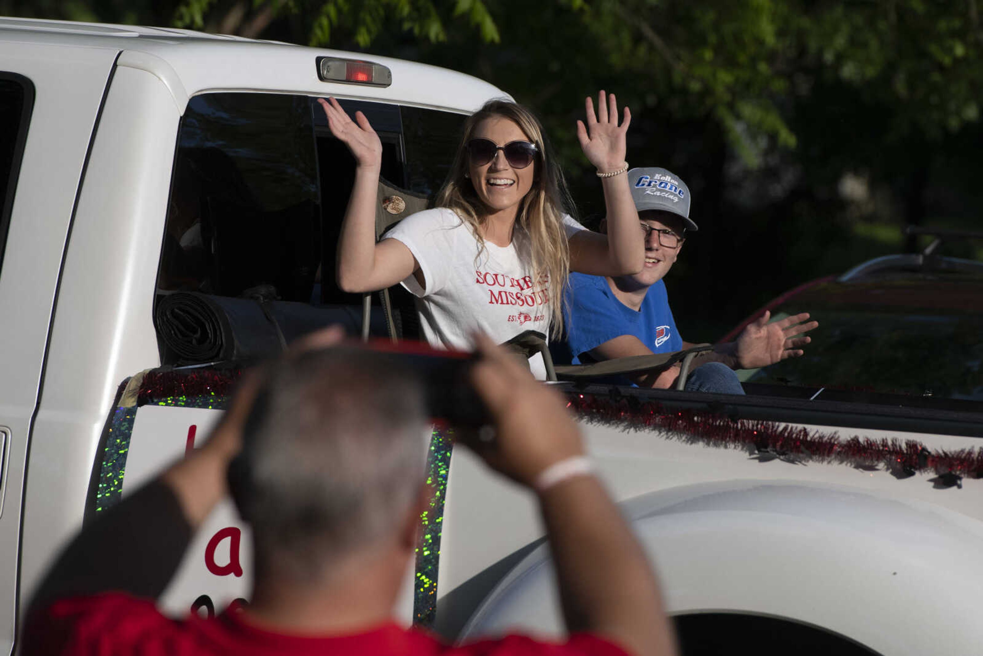 Parade participants wave while taking part in a procession for Jackson High School seniors Friday, May 29, 2020, at Jackson City Park.