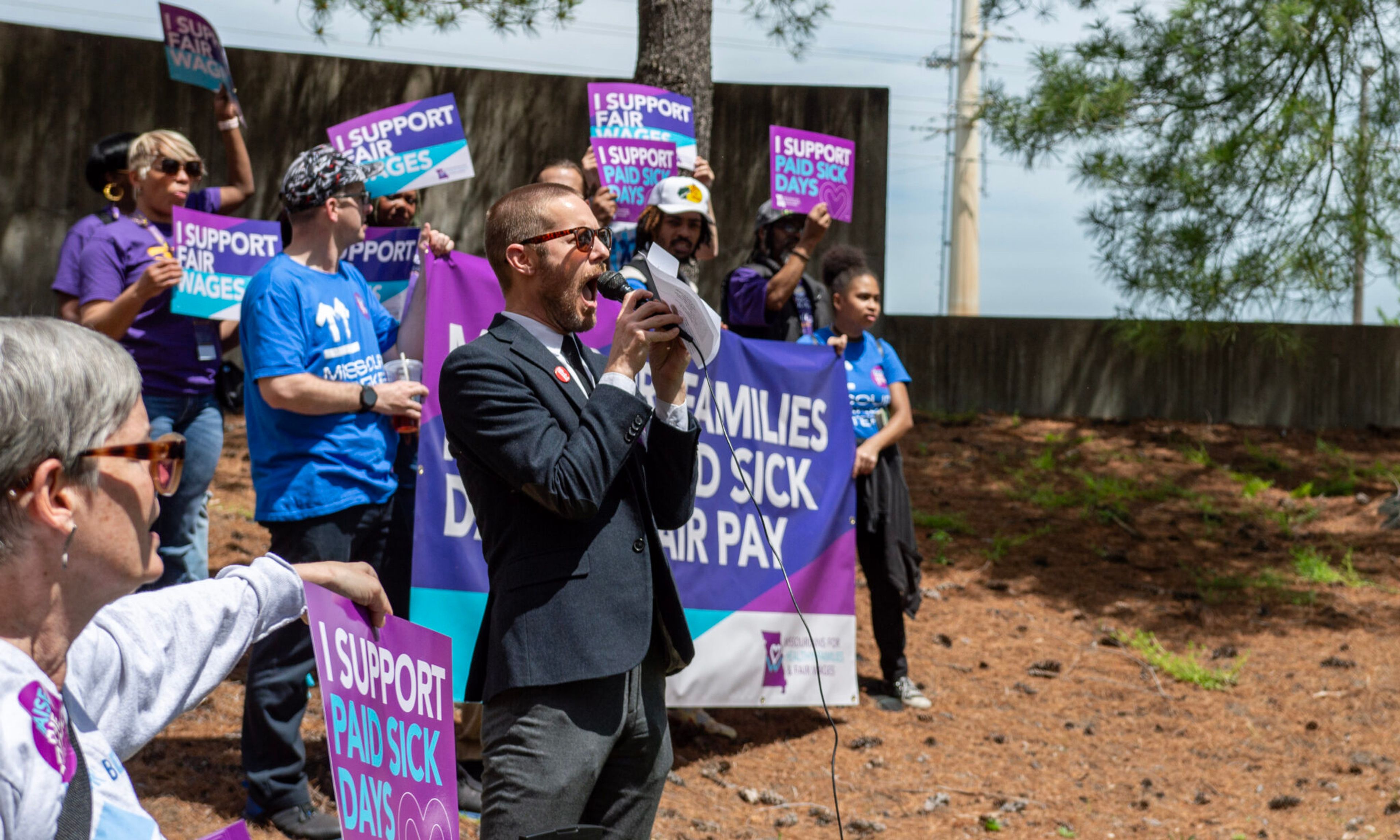 
Daniel Tucker, a leader with the Missouri Workers Center, teaches chants customized to an initiative petition to raise the minumum wage and mandate paid sick leave outside of the Secretary of State's office building in May in Jefferson City.