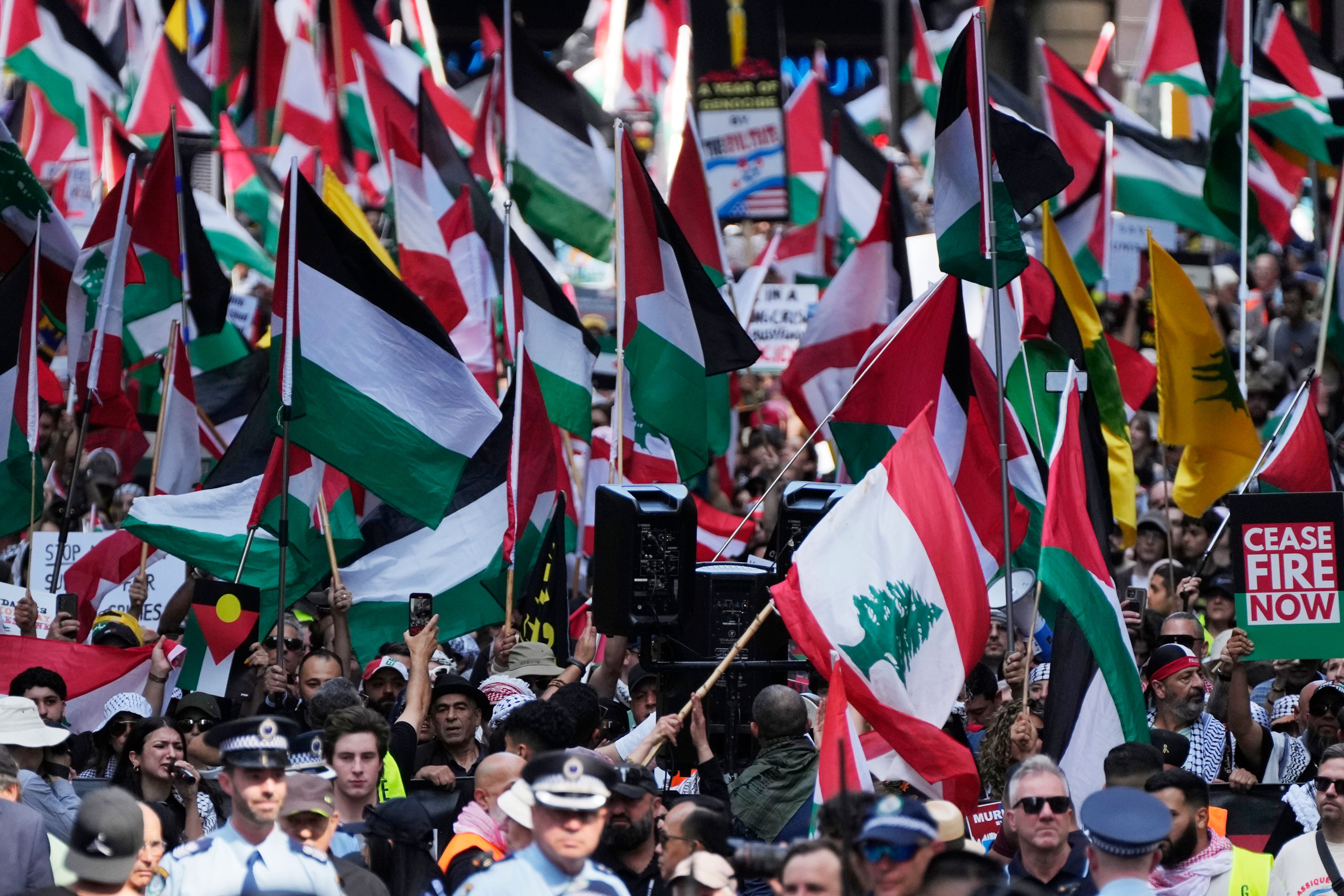 People march on the street as Pro-Palestinian supporters rally in Sydney, Sunday, Oct. 6, 2024. (AP Photo/Rick Rycroft)