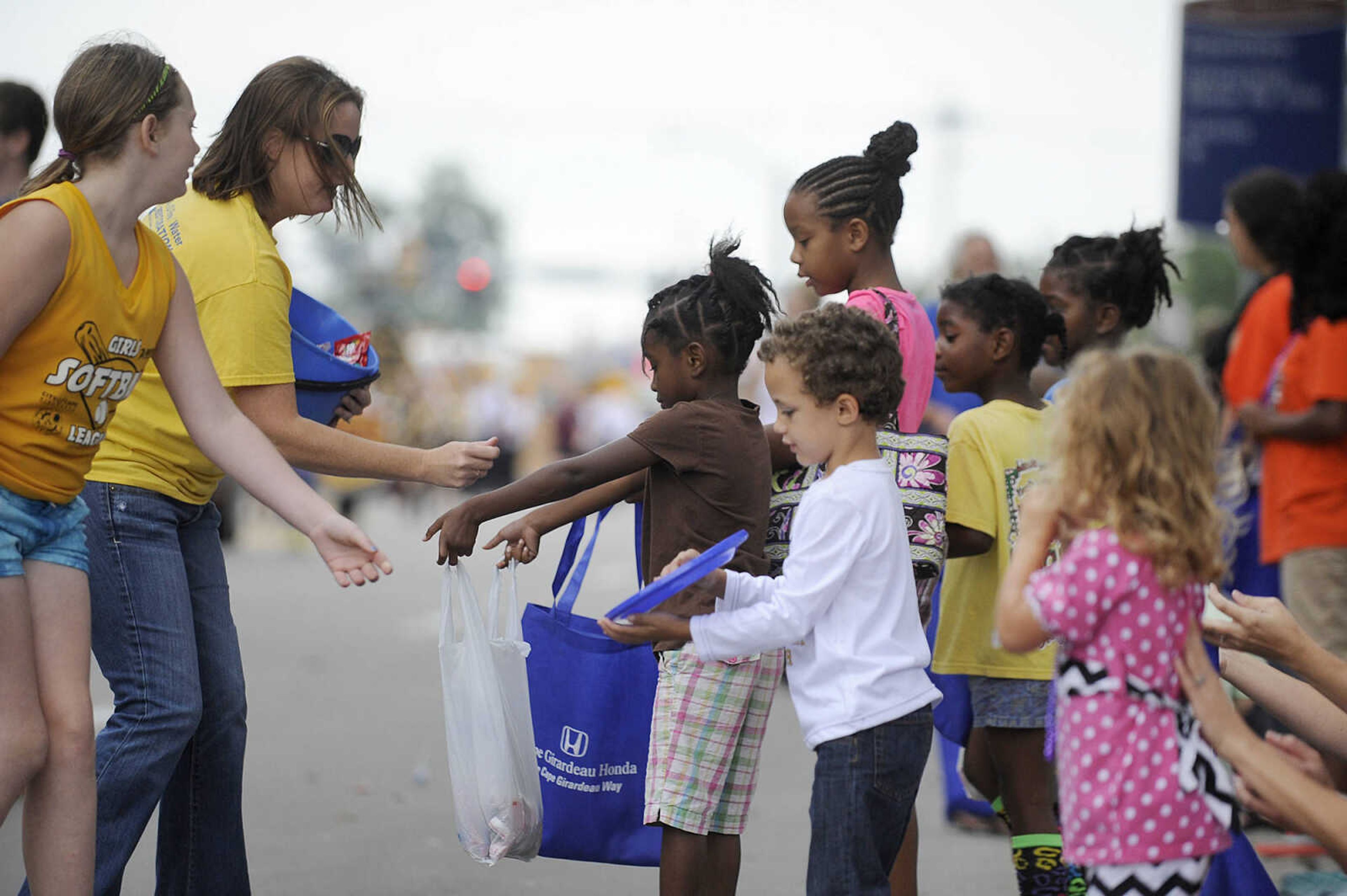 GLENN LANDBERG ~ glandberg@semissourian.com

Children collect candy as the SEMO District Fair Parade heads down Broadway after starting in Capaha Park Saturday morning, Sept. 6, 2014, in Cape Girardeau. The parade ended at Arena Park where the 159th annual SEMO District Fair is being held.