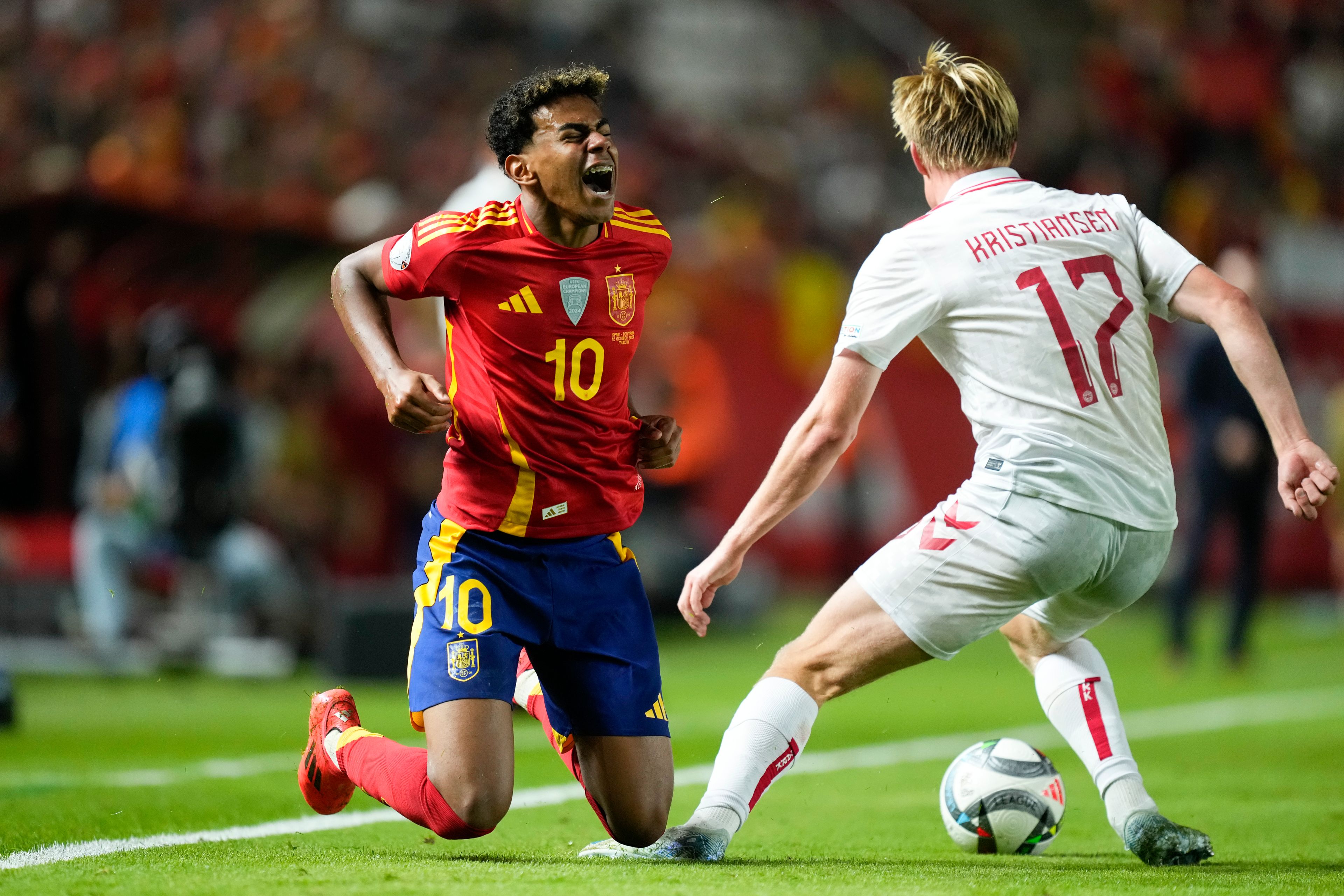 Spain's Lamine Yamal, left, and Denmark's Victor Kristiansen battle for the ball during the UEFA Nations League group 4 soccer match between Spain and Denmark in Murcia, Spain, Saturday, Oct. 12, 2024. (AP Photo/Jose Breton)