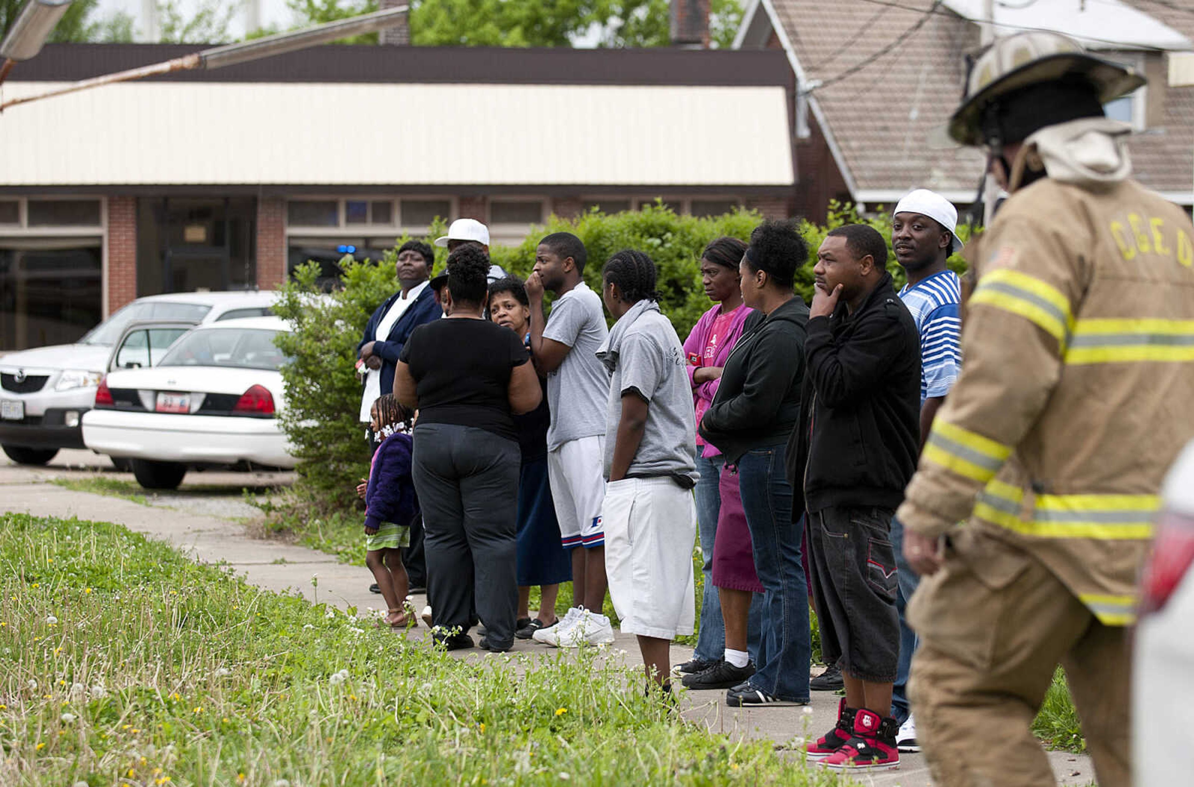 Bystanders look on as the Cape Girardeau Fire Department battles a structure fire at 710 Morgan Oak St., Tuesday, April 29, in Cape Girardeau. A Cape Girardeau Police officer saw the fire and called it in at 1:16 p.m. The building contained two apartments that were home to five people, though no one was home at the time of the fire. The cause of the fire is under investigation.