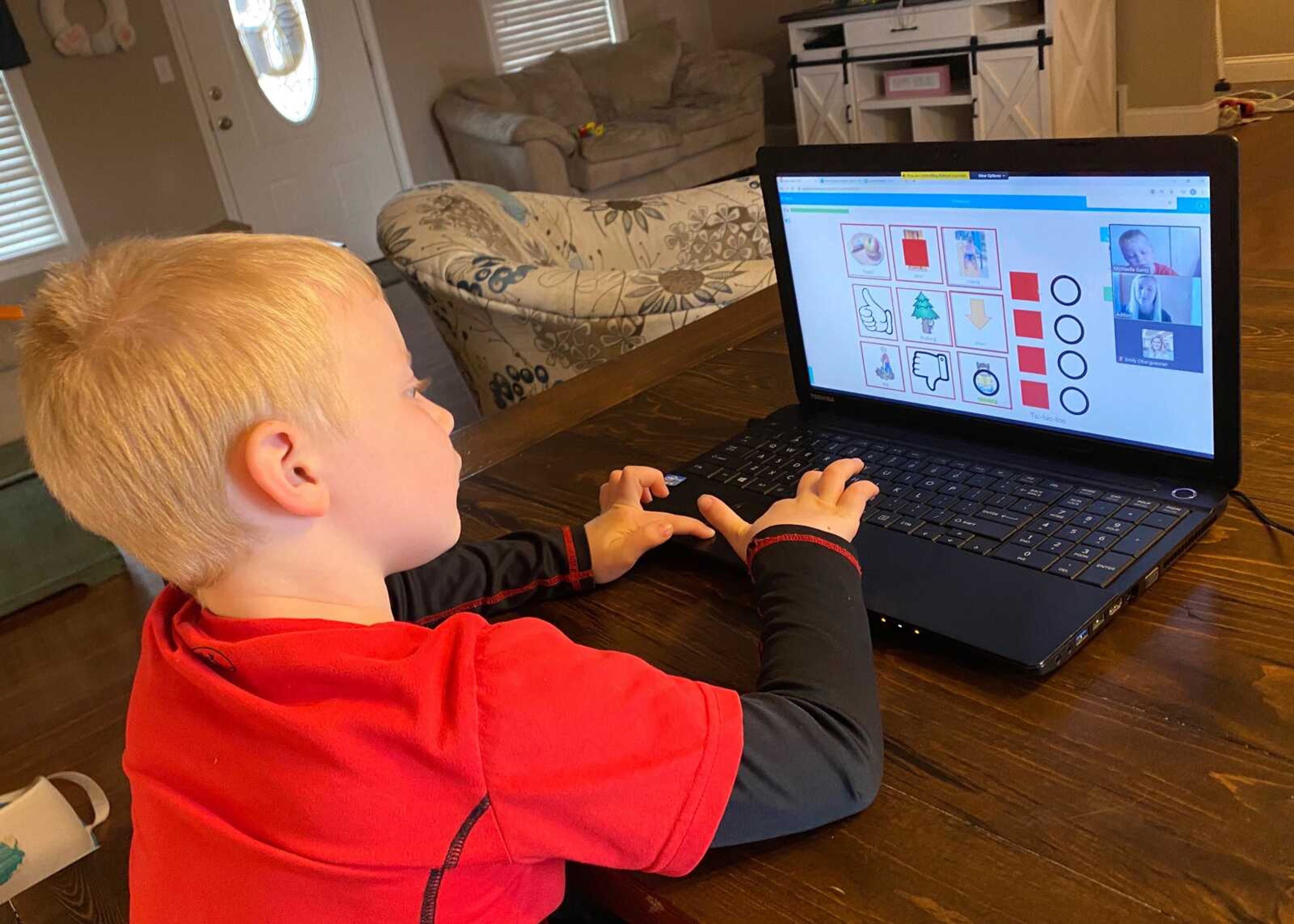 Grayson Gantz works at a laptop during a teletherapy session with student clinician Ashton Glascock from Southeast Missouri State University's Center for Speech and Hearing on March 31 at his Gordonville home.