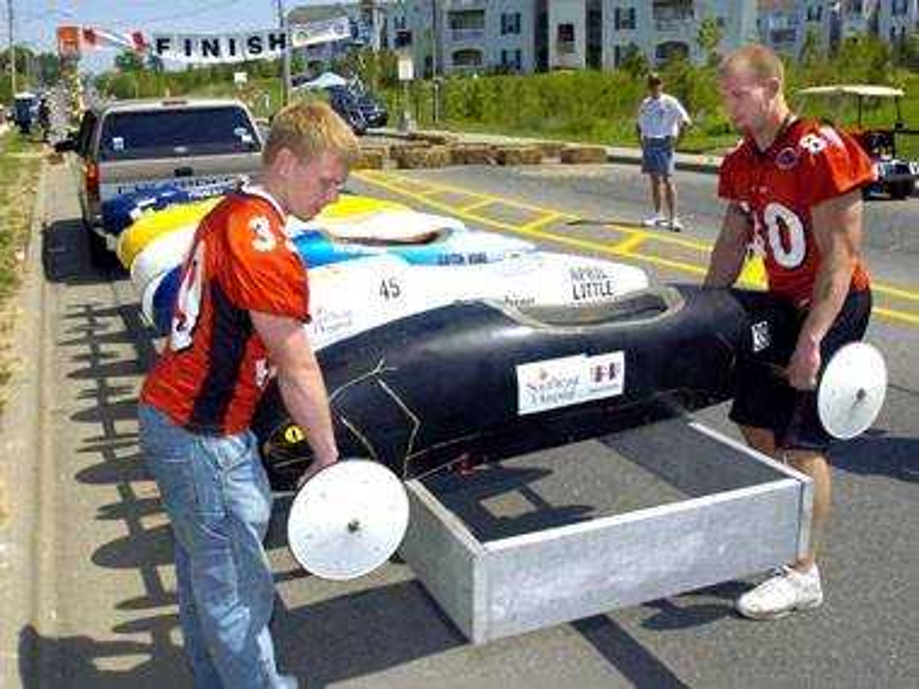 Redhawks football players, including Jim Todd, left, and Kyle Hunt from Southeast Missouri State University, loaded Soap Box Derby cars onto a trailer for transport up the hill.