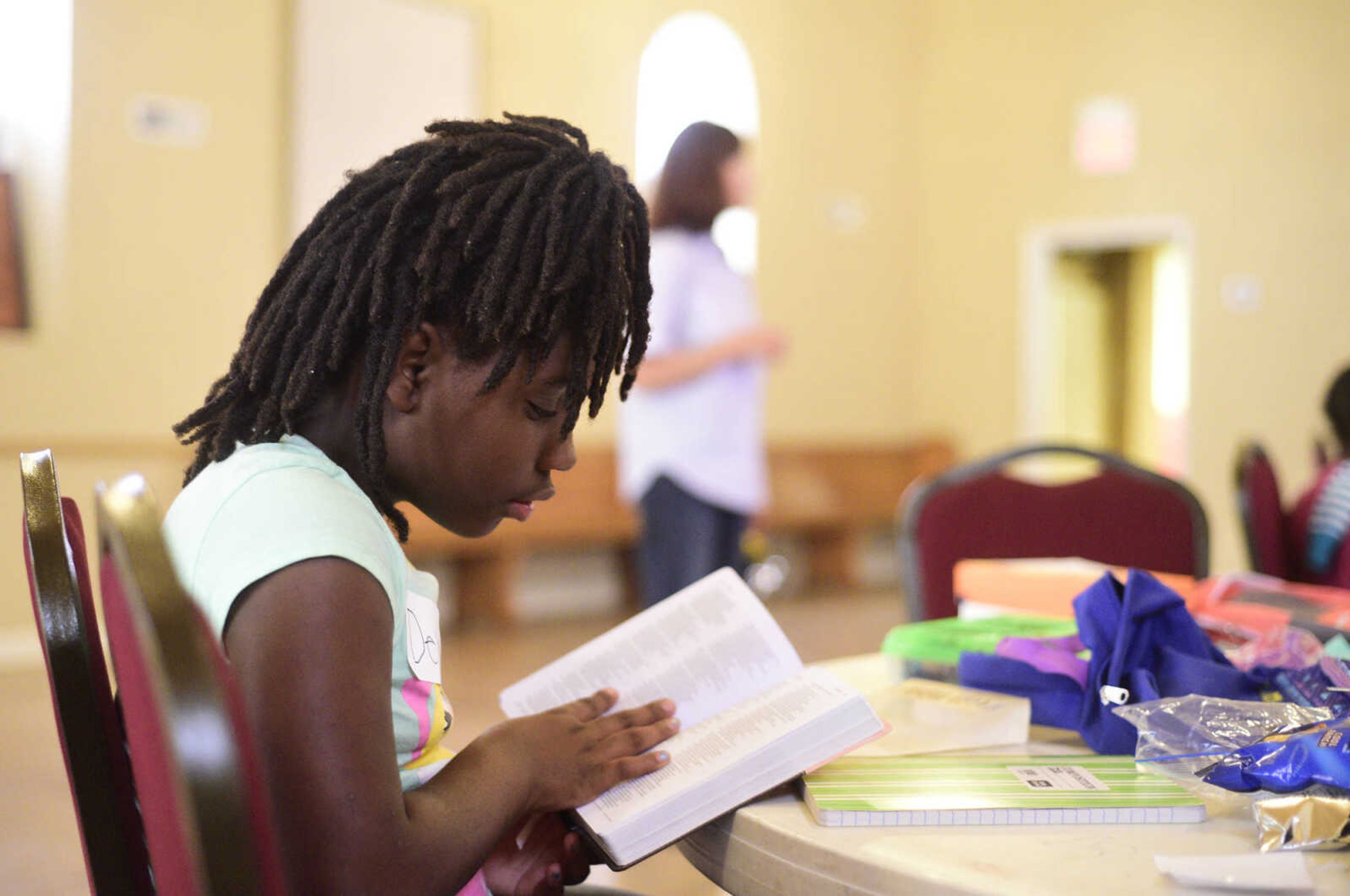 Deja Maney reads a psalm from her bible on Monday, Aug. 14, 2017, during the Salvation Army's after school program at The Bridge Outreach Center in Cape Girardeau.