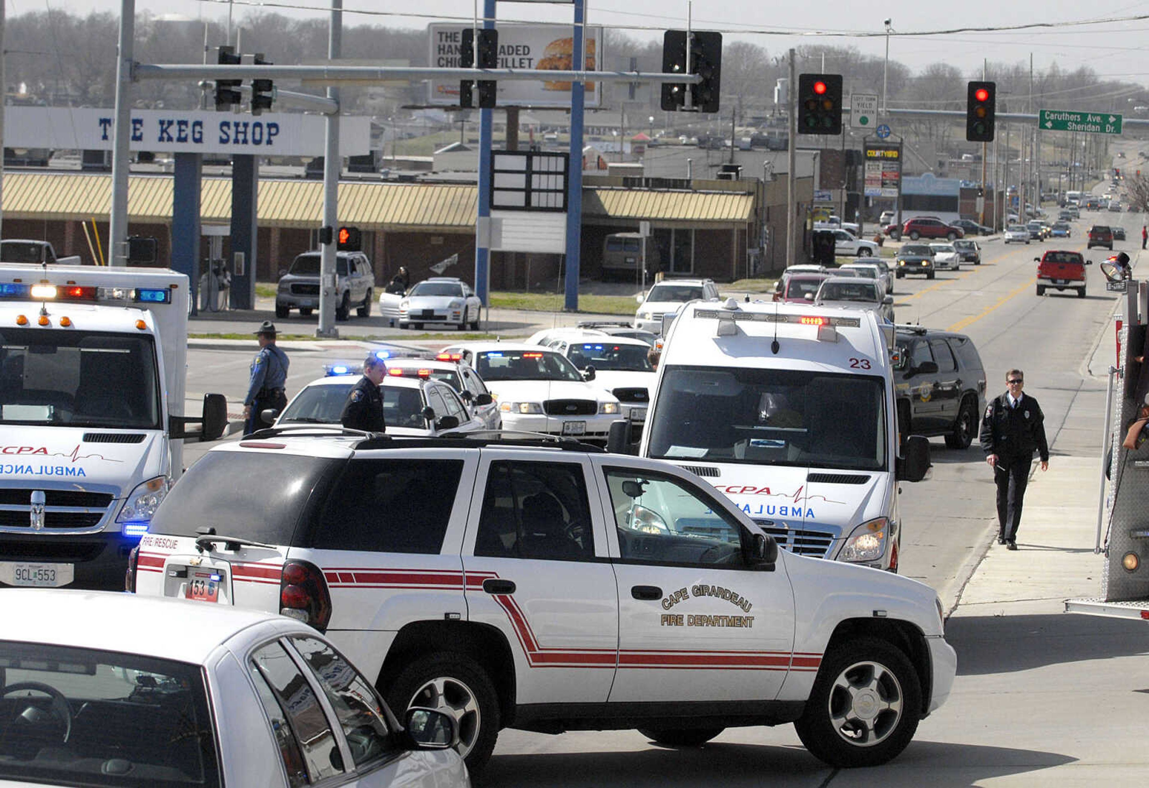 LAURA SIMON ~ lsimon@semissourian.com
Cape Girardeau emergency responders work the scene of a victim of a self-inflicted gun shot wound outside Dan's Key and Lock Tuesday afternoon, March 6, 2012. Police say the man is a suspect in a Sunday assault along Cape LaCroix Recreational Trail.