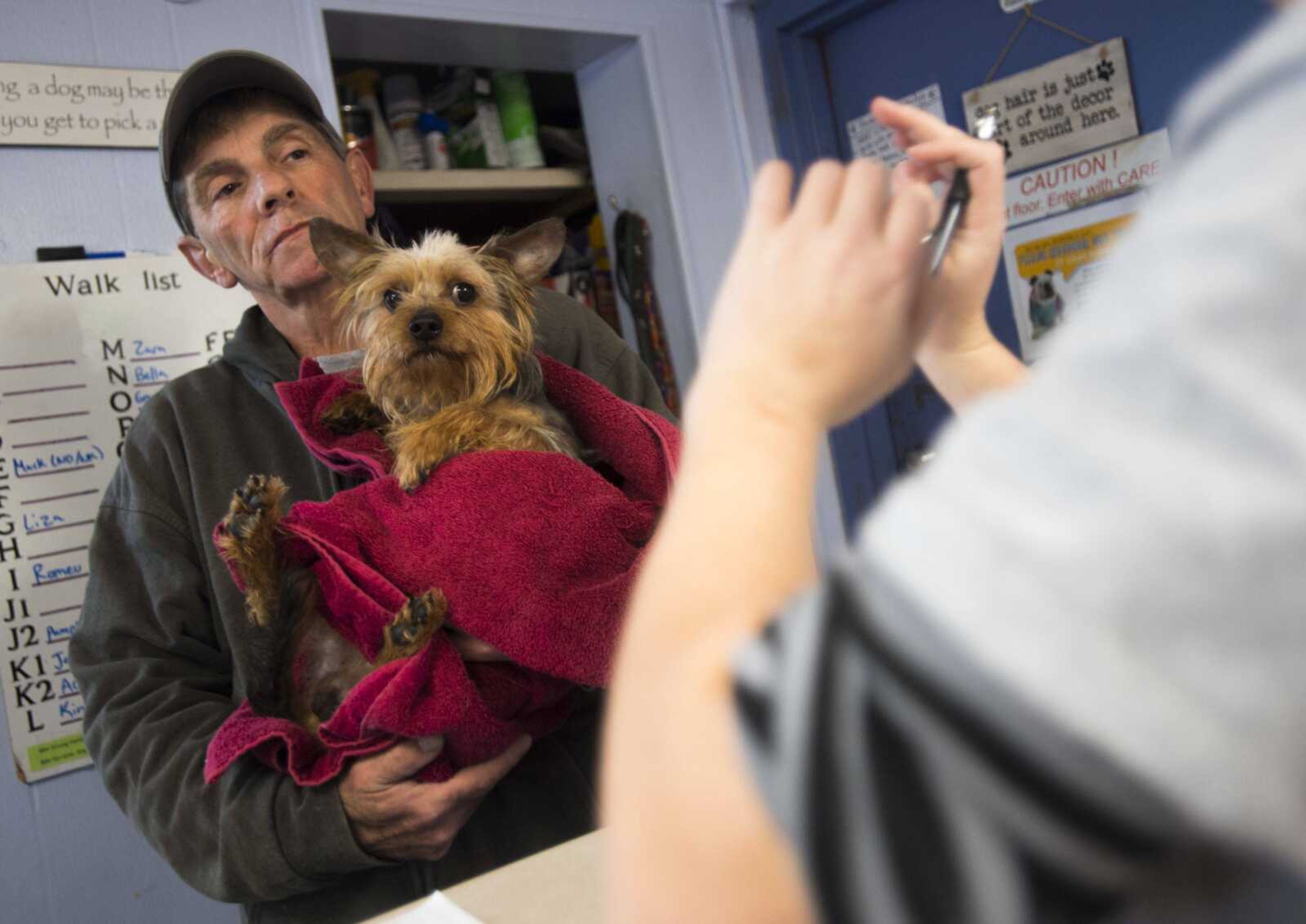 Kenny Speakman carries a rescued dog during an intake evaluation Tuesday, Jan. 2, 2018, at the Humane Society of Southeast Missouri in Cape Girardeau.