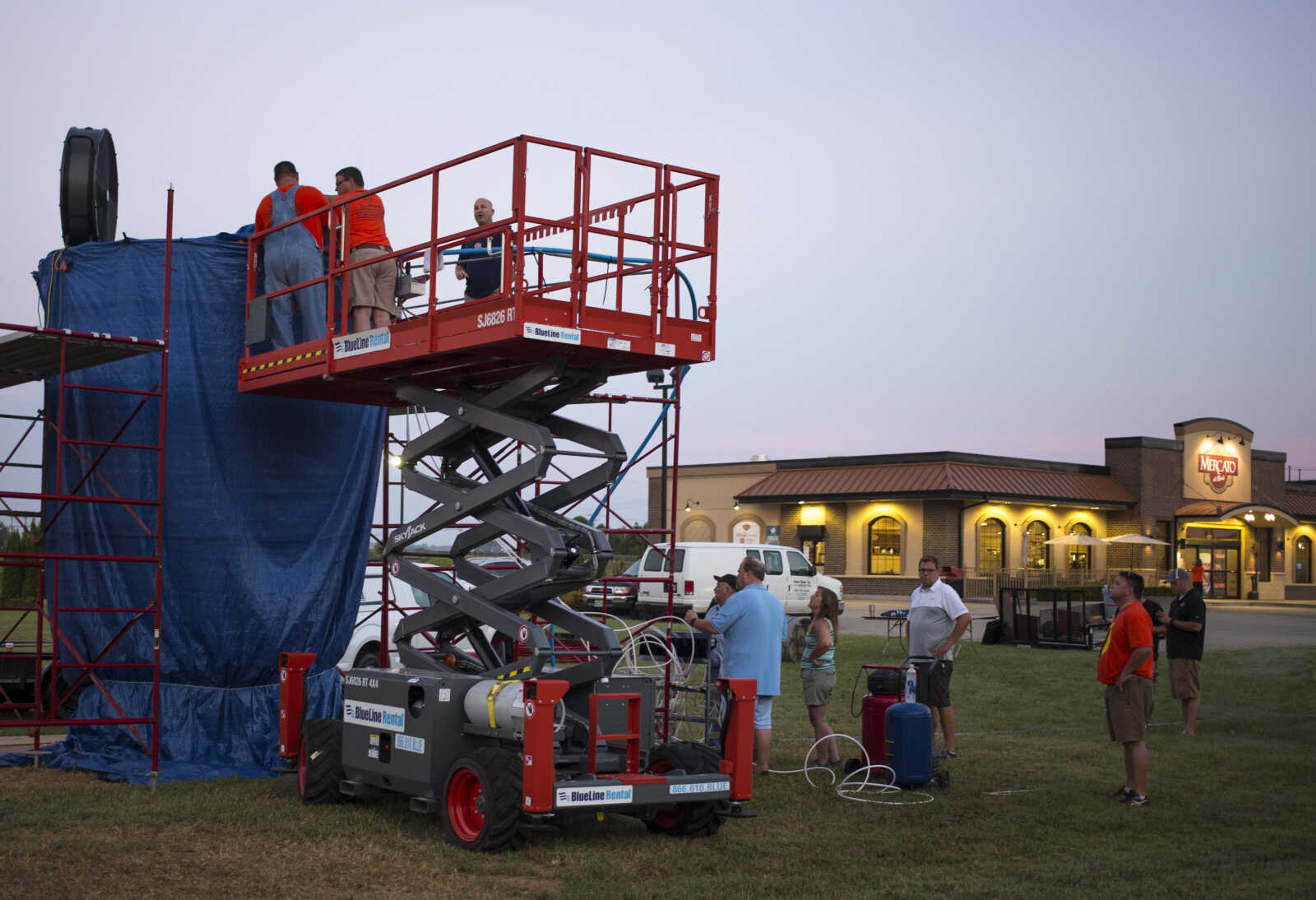 Rhodes employees fill a 15-foot cup with lemonade at Mercato di Rodi in Cape Girardeau early Sunday morning in an attempt to break the Guinness World Record for largest cup/glass of soft drink.