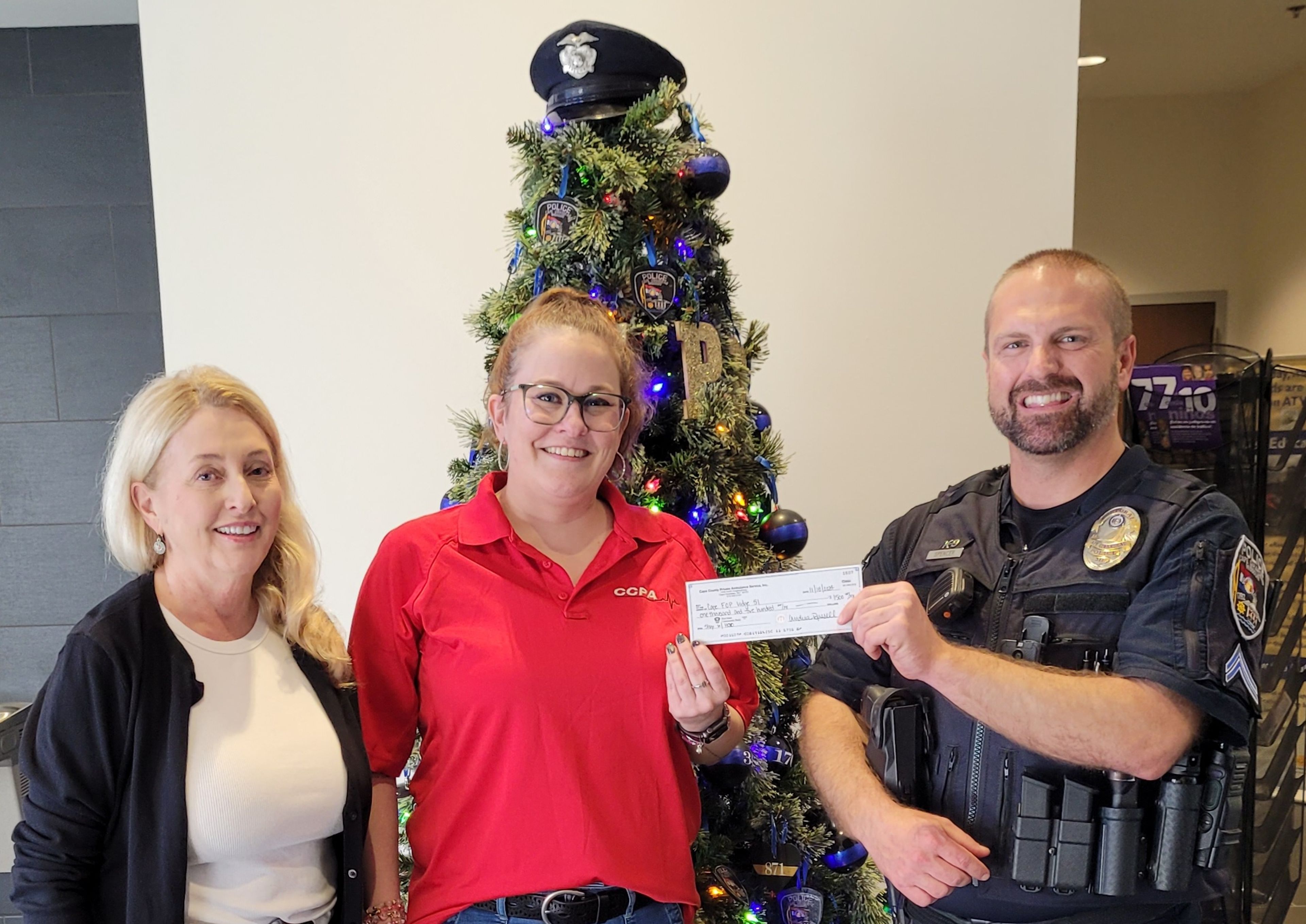 Susan Russell and Andrea Russell of Cape County Private Ambulance gives a check for $1500 to Cpl. Johnny Spencer of the Cape Fraternal Order of Police Lodge 51 to provide needy children funds to Shop with a Hero at the Cape Supercenter in December.